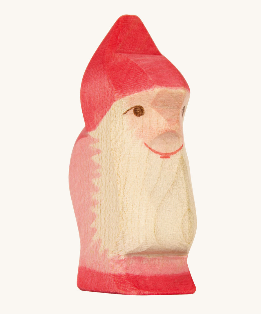 A red wooden Ostheimer dwarf figure on a cream background.