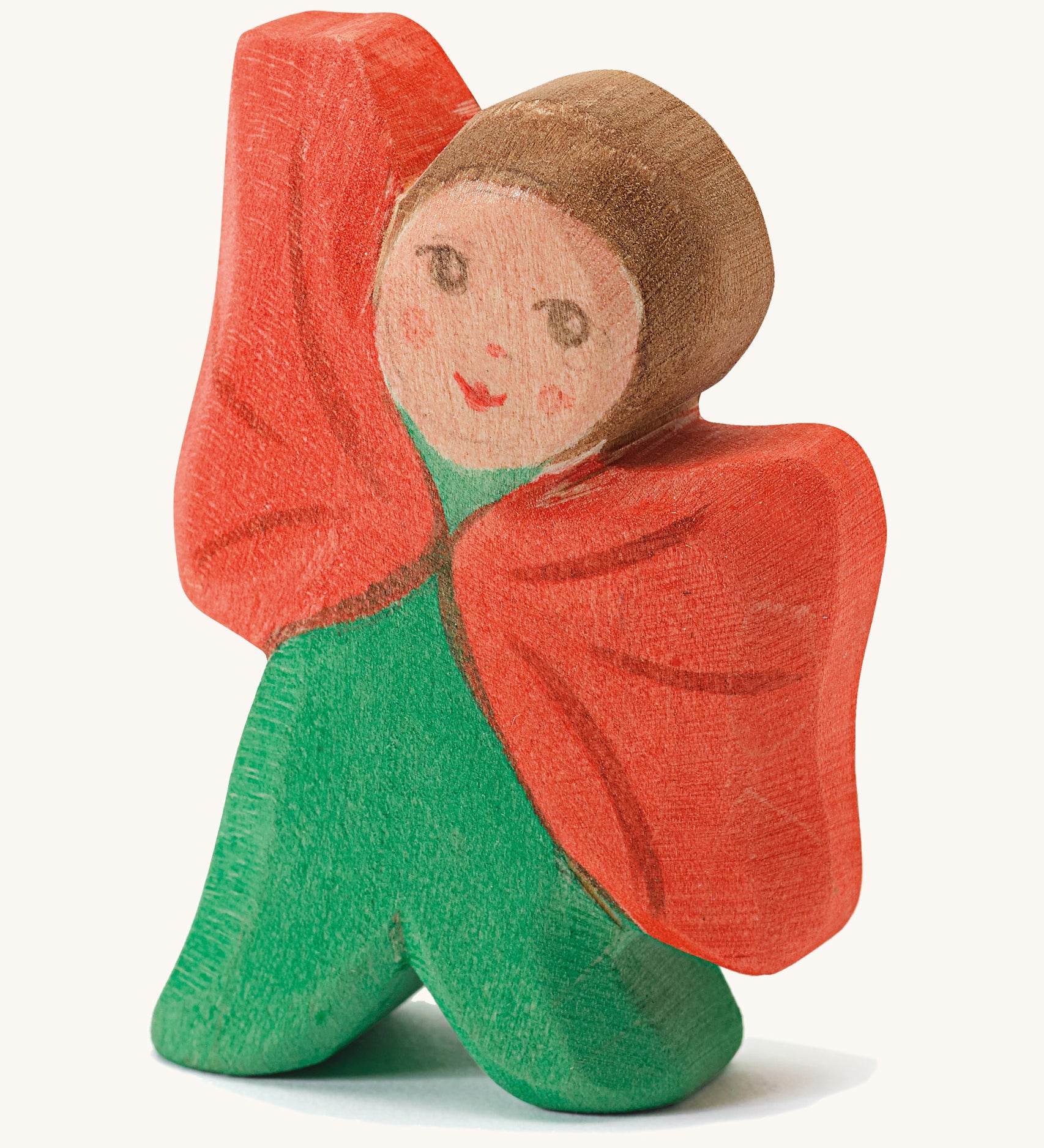 Ostheimer Wooden Toy Flower Child - Poppy. A beautifully hand crafted and hand painted Ostheimer Flower Child in a green outfit with a red cape, on a cream background