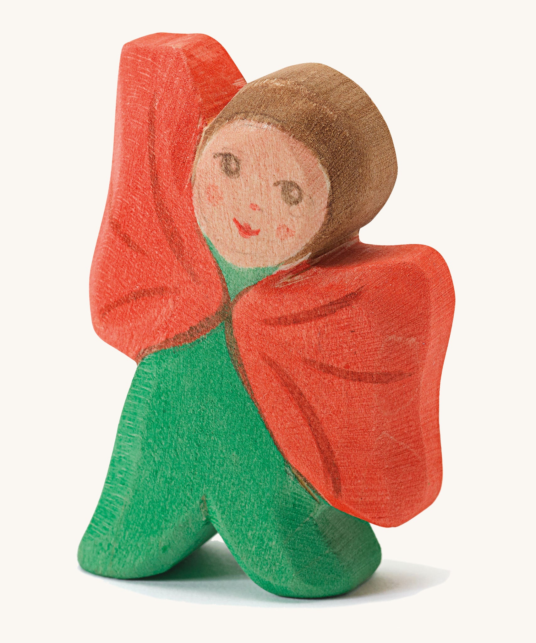 Ostheimer Wooden Toy Flower Child - Poppy. A beautifully hand crafted and hand painted Ostheimer Flower Child in a green outfit with a red cape, on a cream background