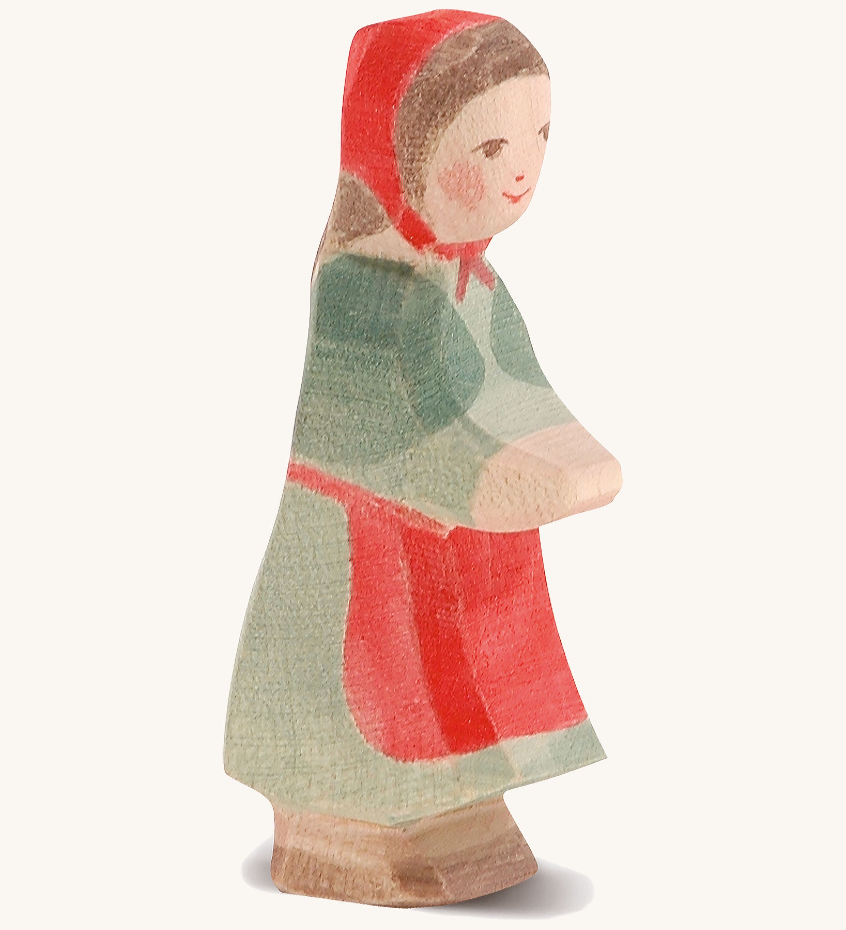 A wooden Ostheimer little red riding hood figure on a cream background