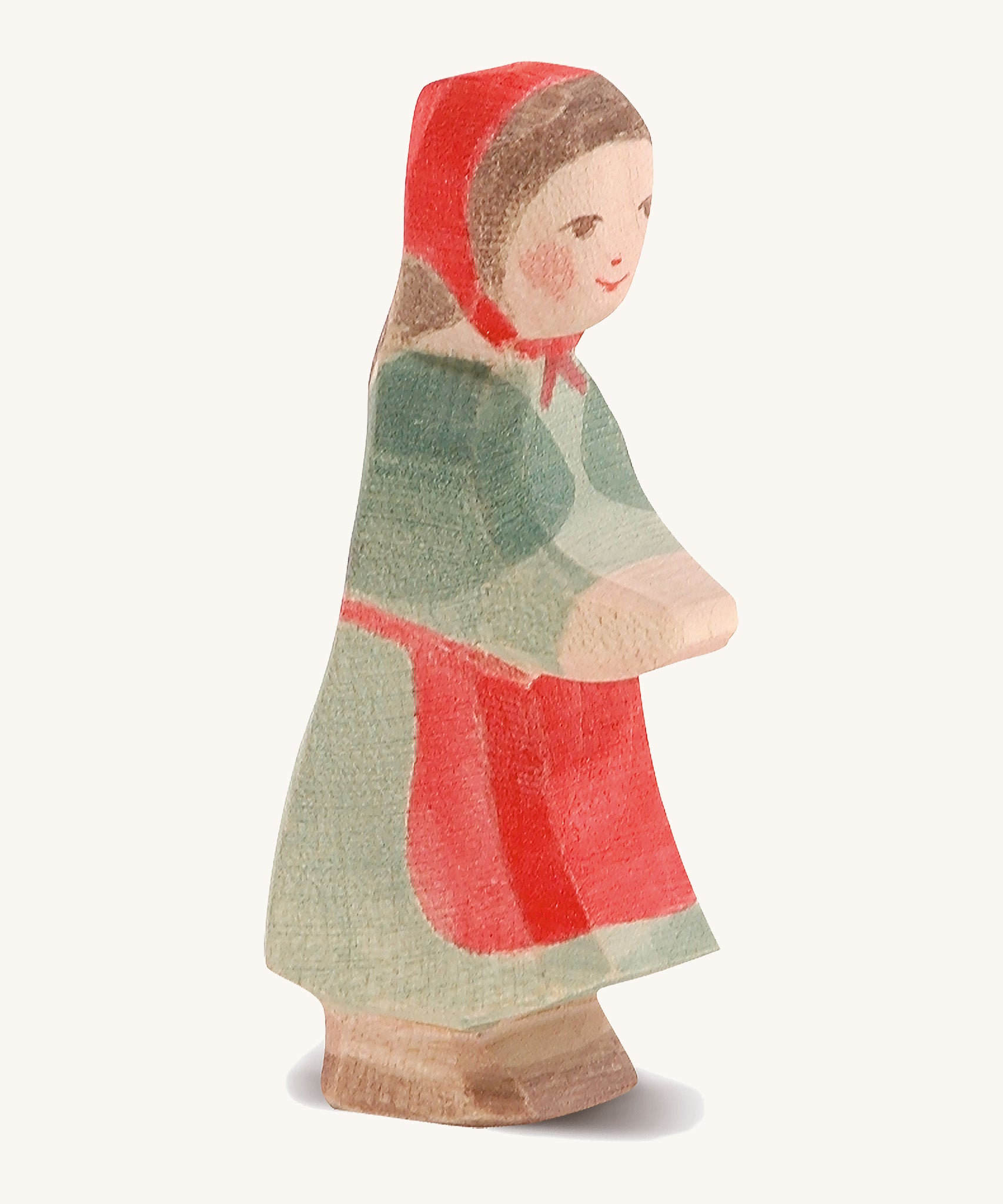 A wooden Ostheimer little red riding hood figure on a cream background