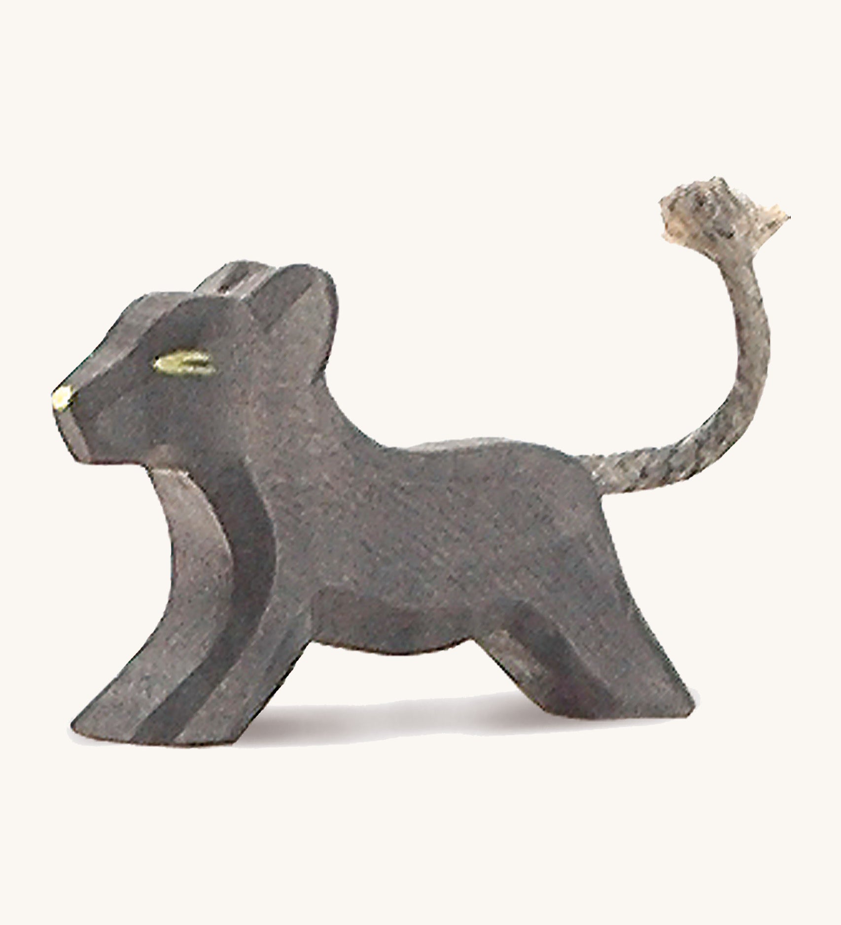 A small wooden Ostheimer running panther on a cream background.