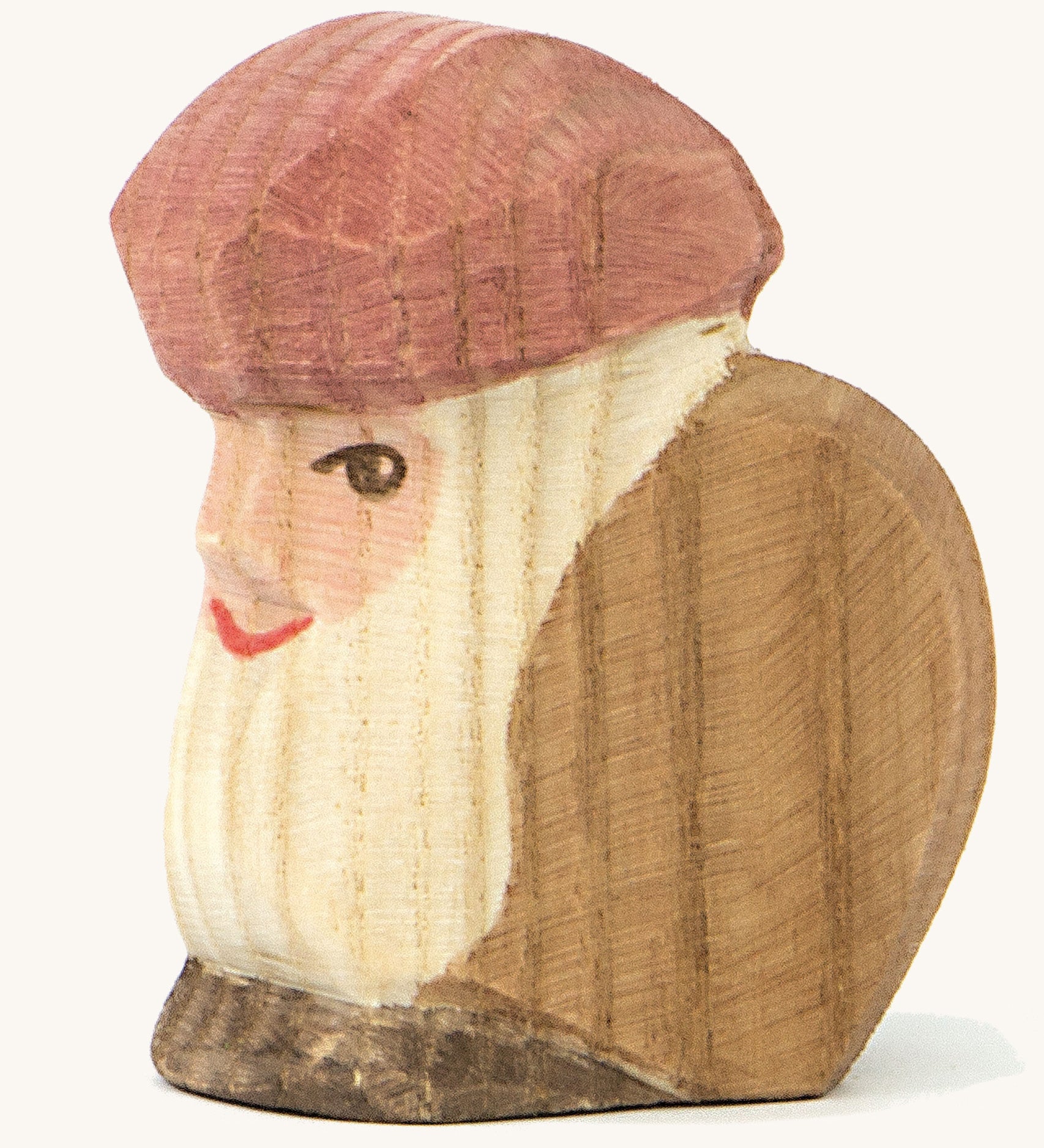 A wooden sitting dwarf wearing a brown top and a purple hat on a cream background.