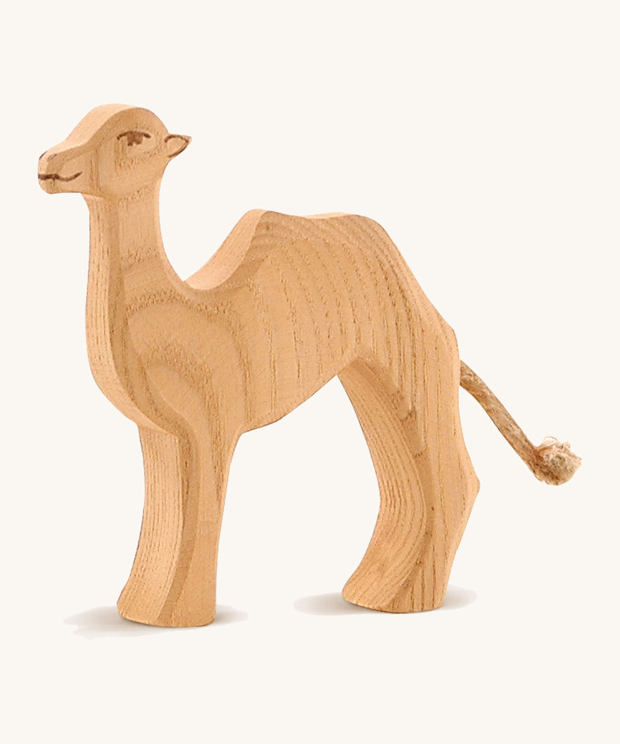 A small wooden Ostheimer camel on a cream background.