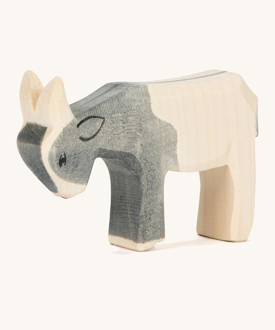 A black and white wooden Ostheimer kid goat figure on a cream background.