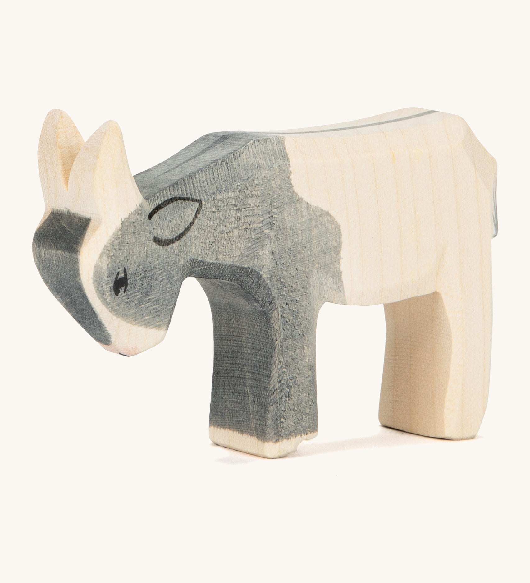 A black and white wooden Ostheimer kid goat figure on a cream background.