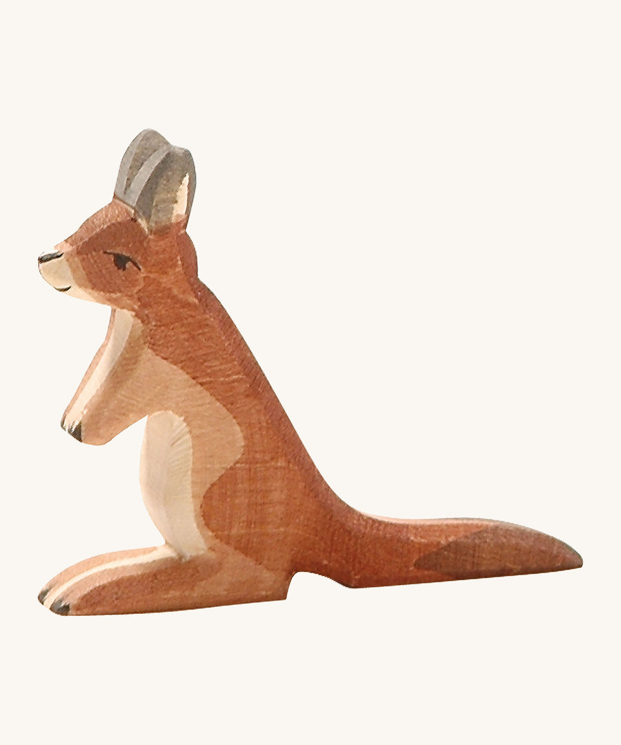 A small wooden Ostheimer kangaroo figure on a cream background.