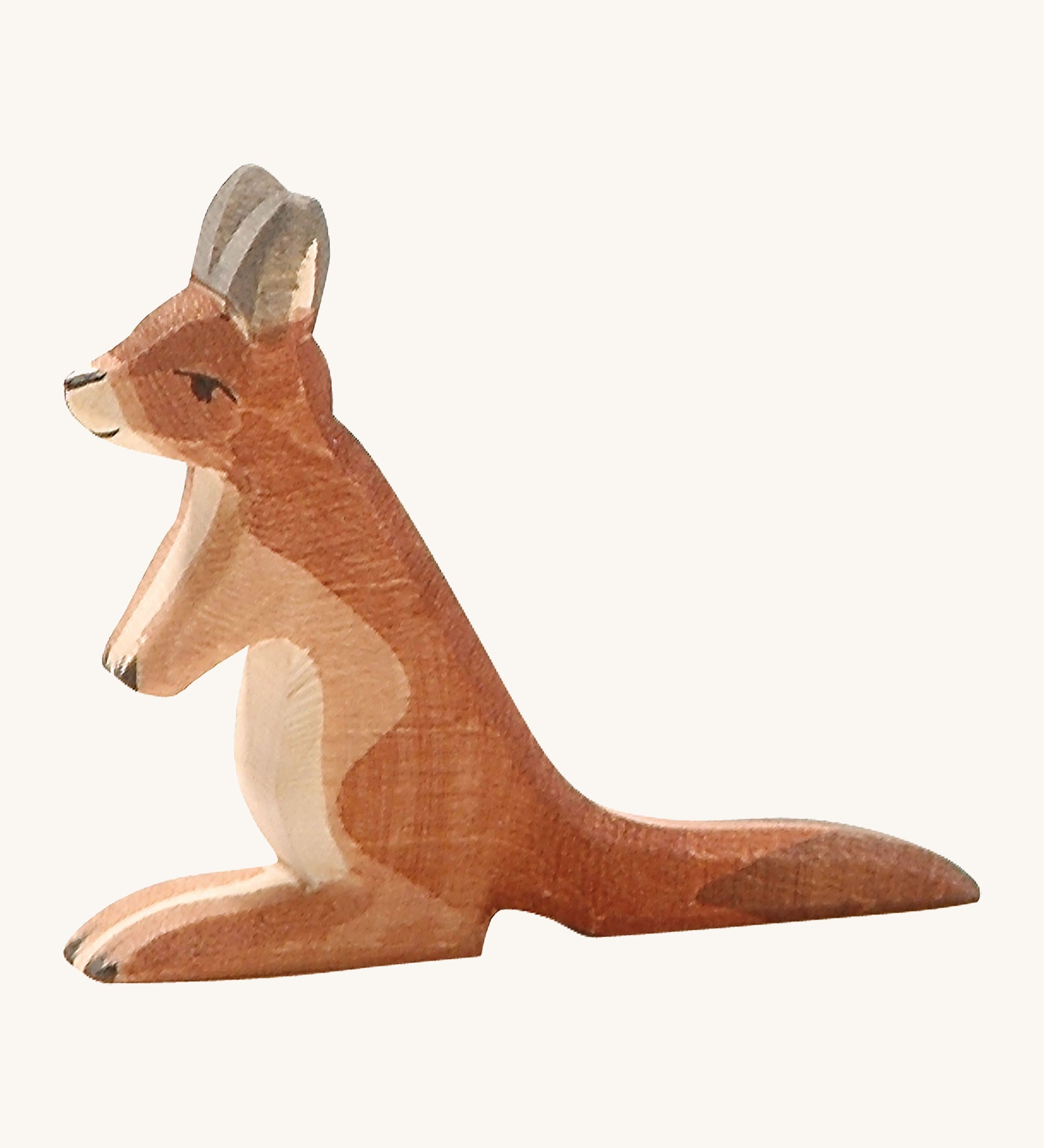 A small wooden Ostheimer kangaroo figure on a cream background.