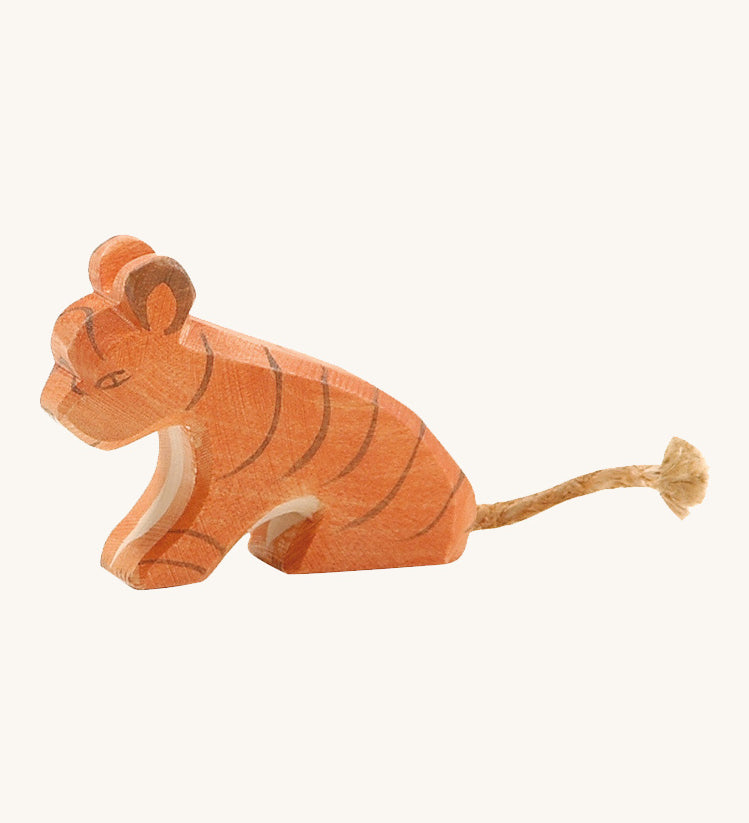 A small sitting Ostheimer tiger figure on a cream background.