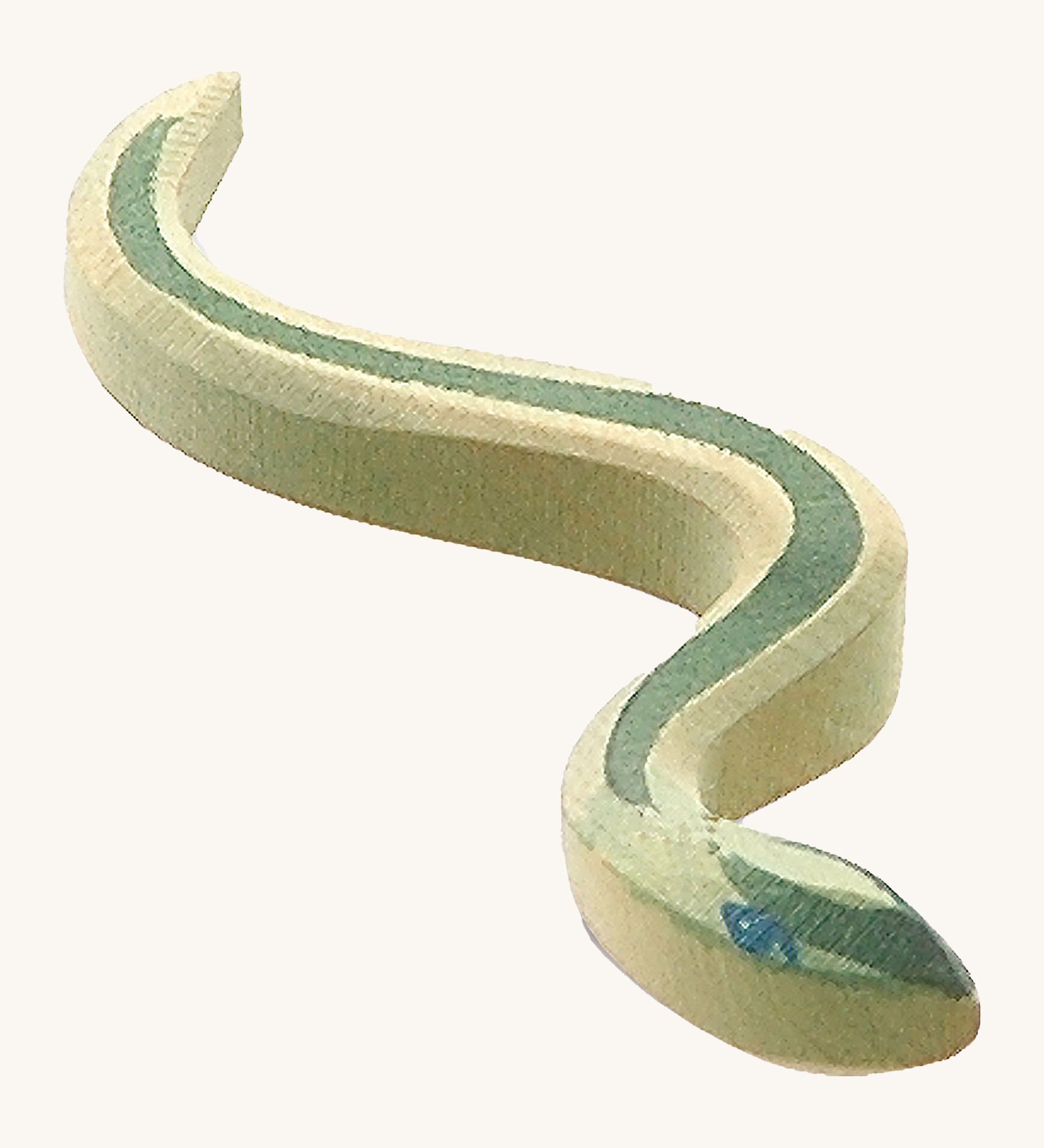 A green wooden Ostheimer snake with blue eyes on a cream backgrouund.