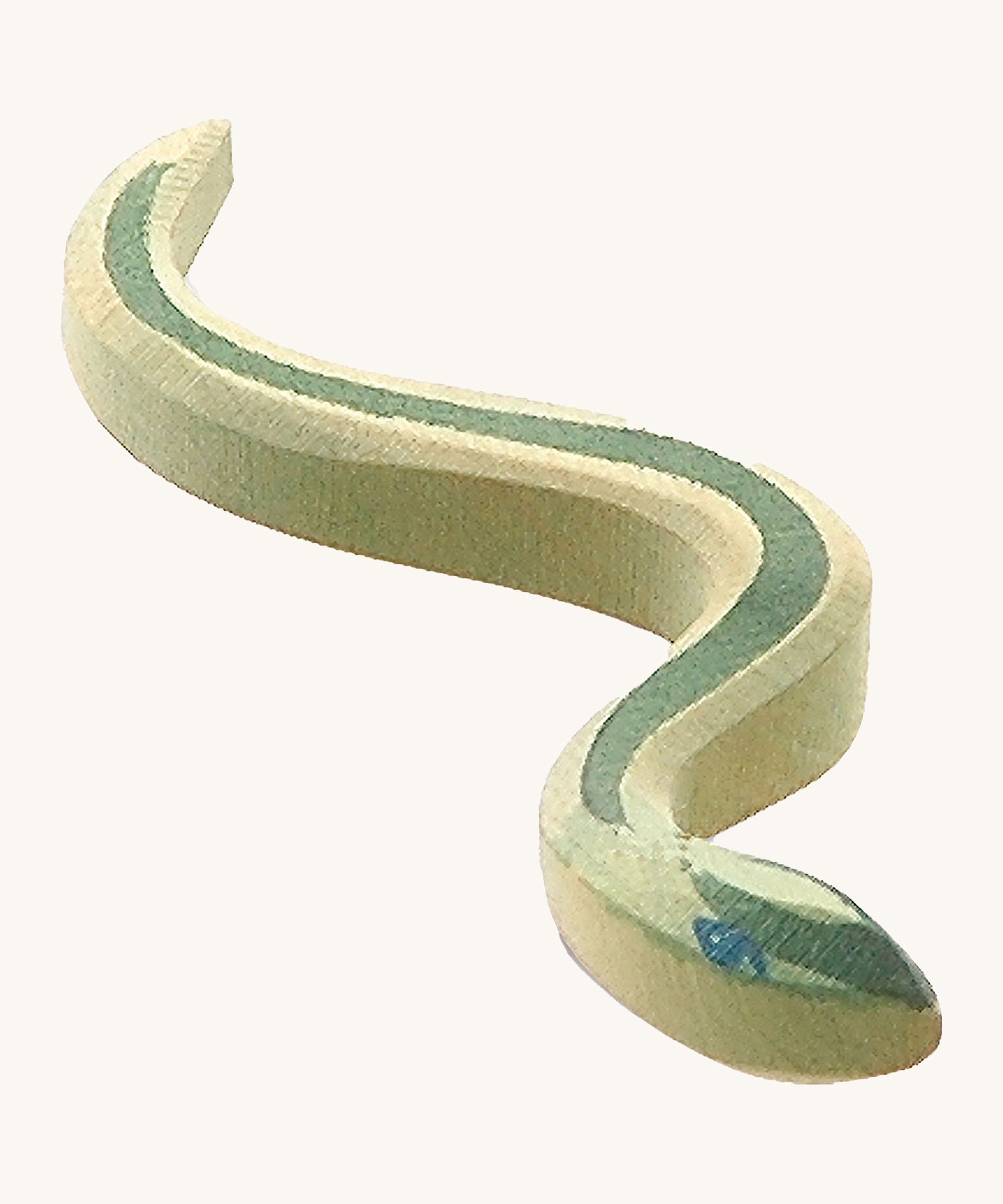 A green wooden Ostheimer snake with blue eyes on a cream backgrouund.