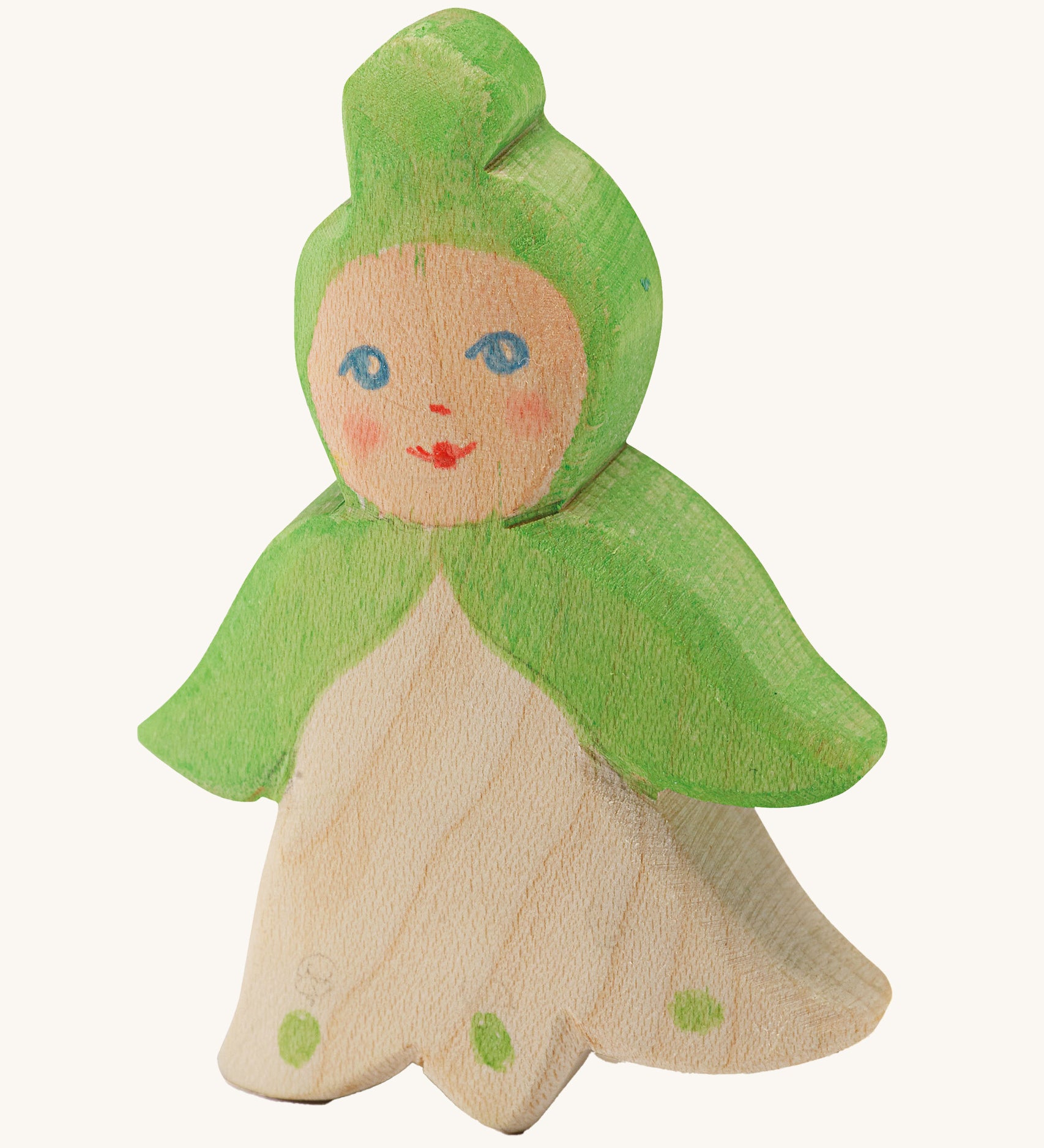 A wooden Ostheimer snowflake flower child figure on a cream background.