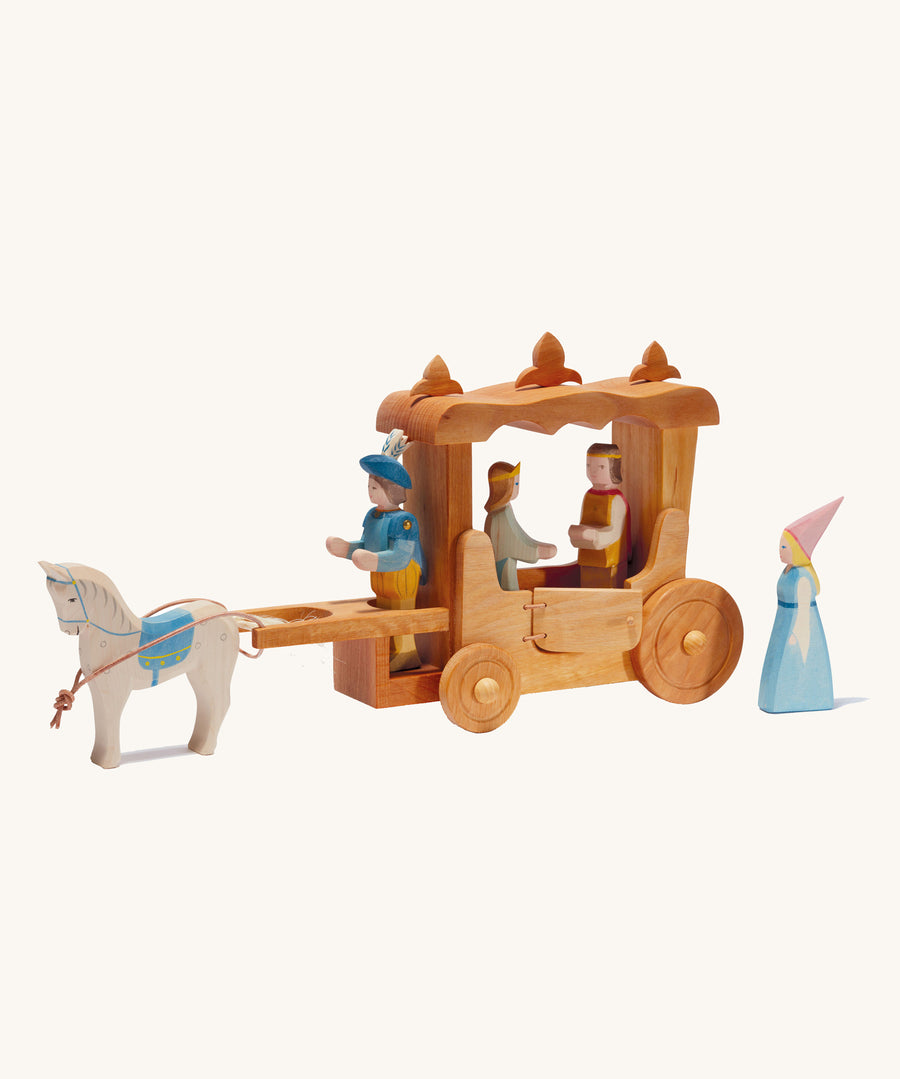 Ostheimer Wooden Stage Coach toy on a plain background. The coach is surrounded by wooden figures of people and a horse.  