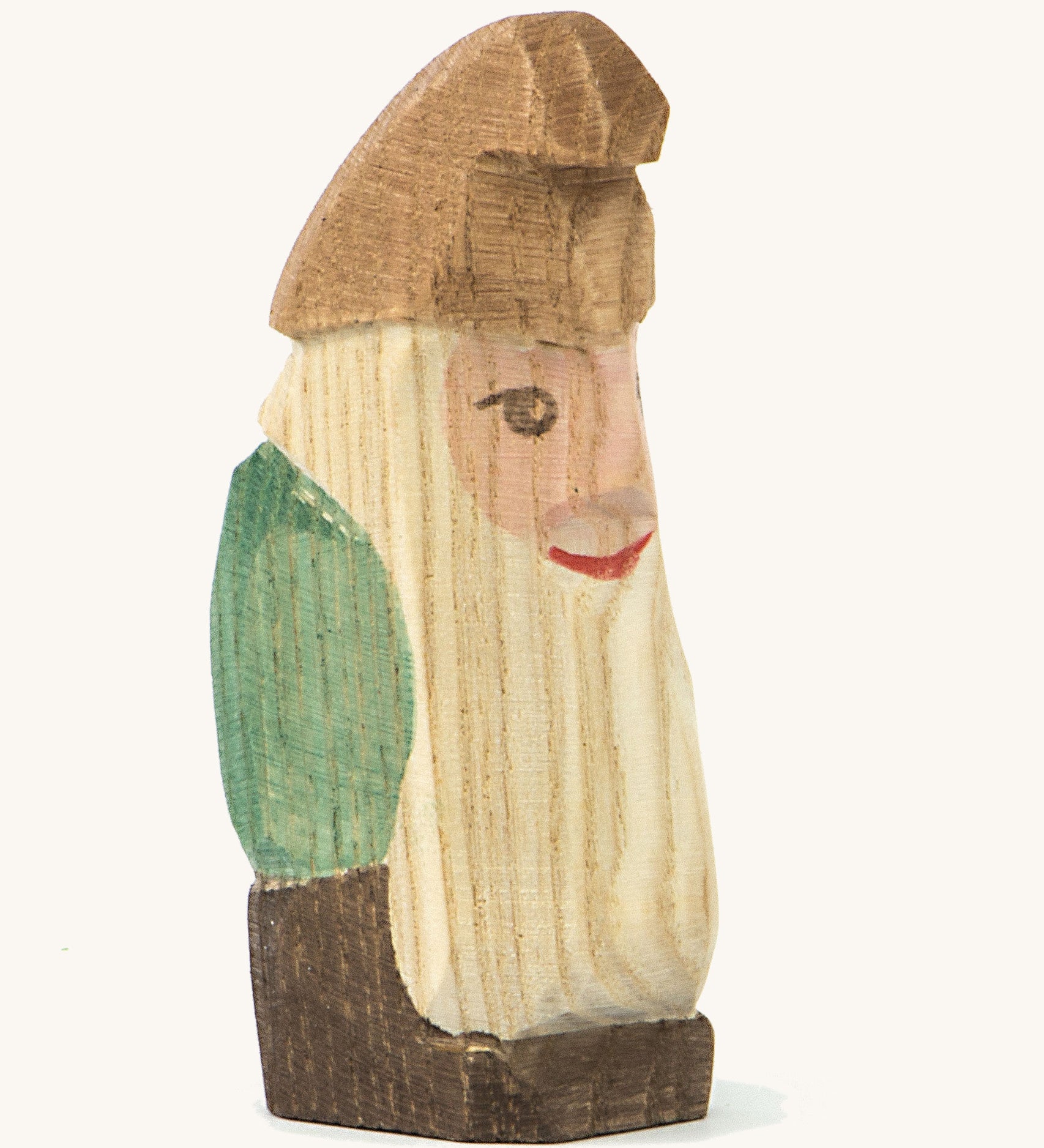 A wooden standing Ostheimer fir tree dwarf wearing a green top and a brown hat on a cream background