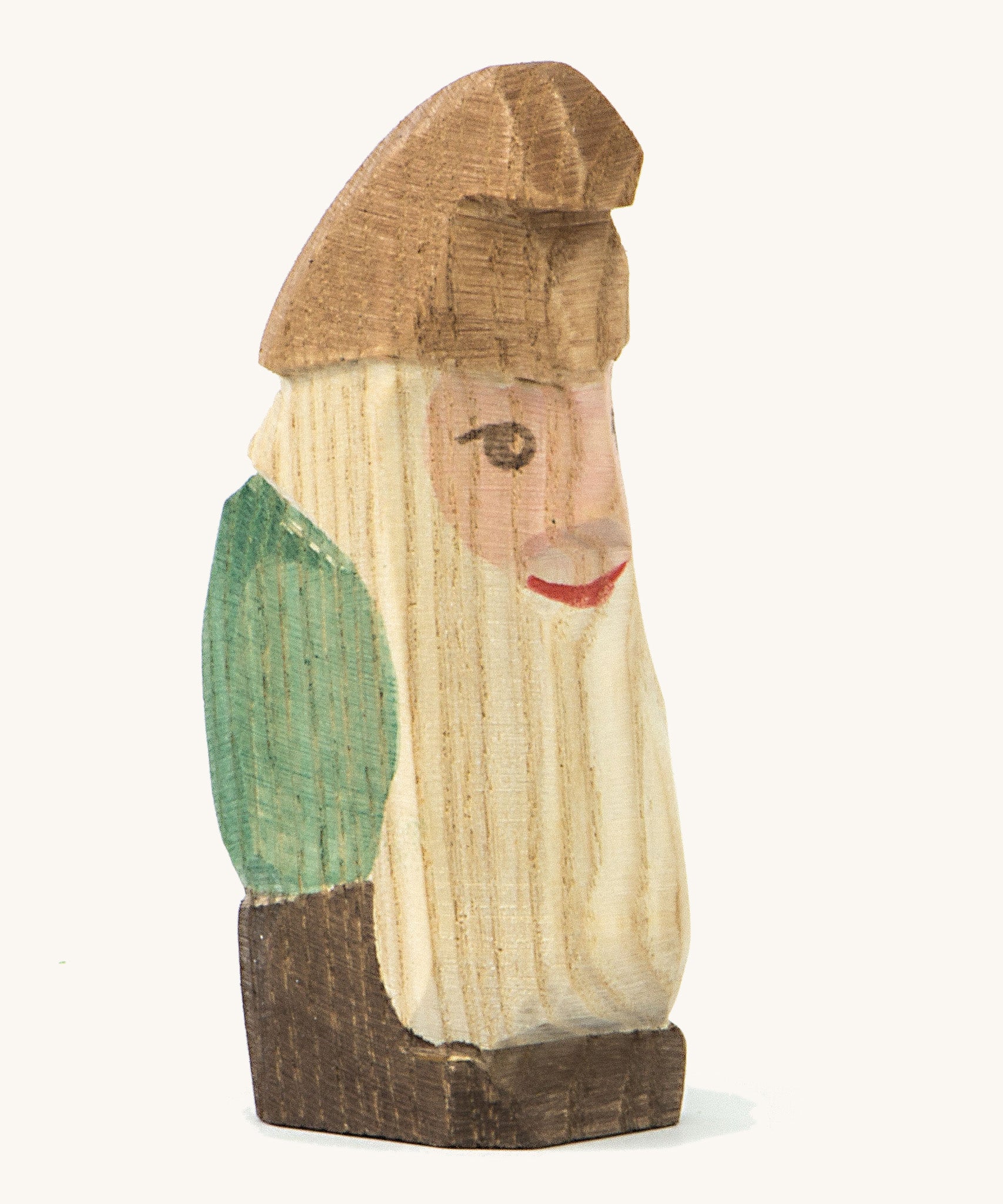 A wooden standing Ostheimer fir tree dwarf wearing a green top and a brown hat on a cream background