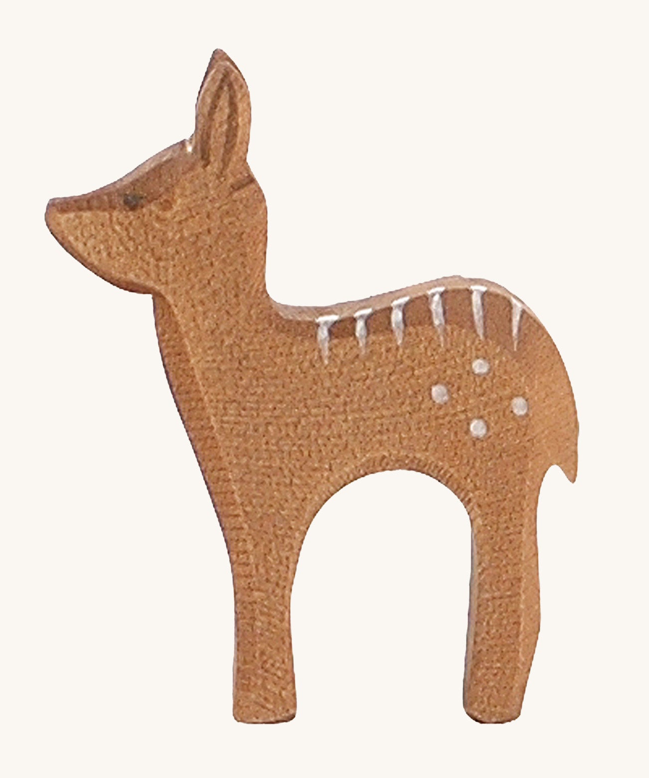 A wooden standing Ostheimer fawn figure on a cream background.