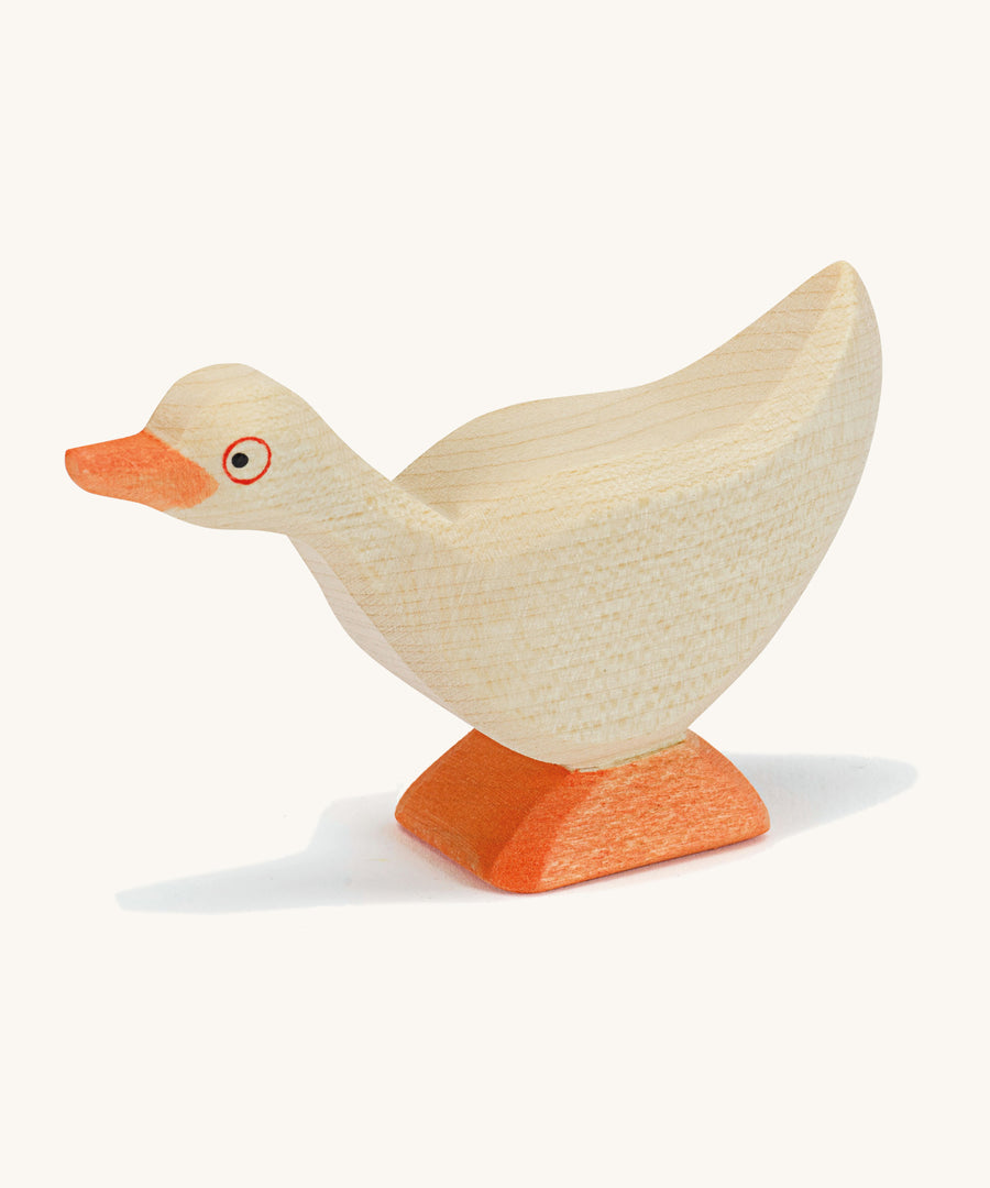 A white wooden Ostheimer standing goose on a cream background.