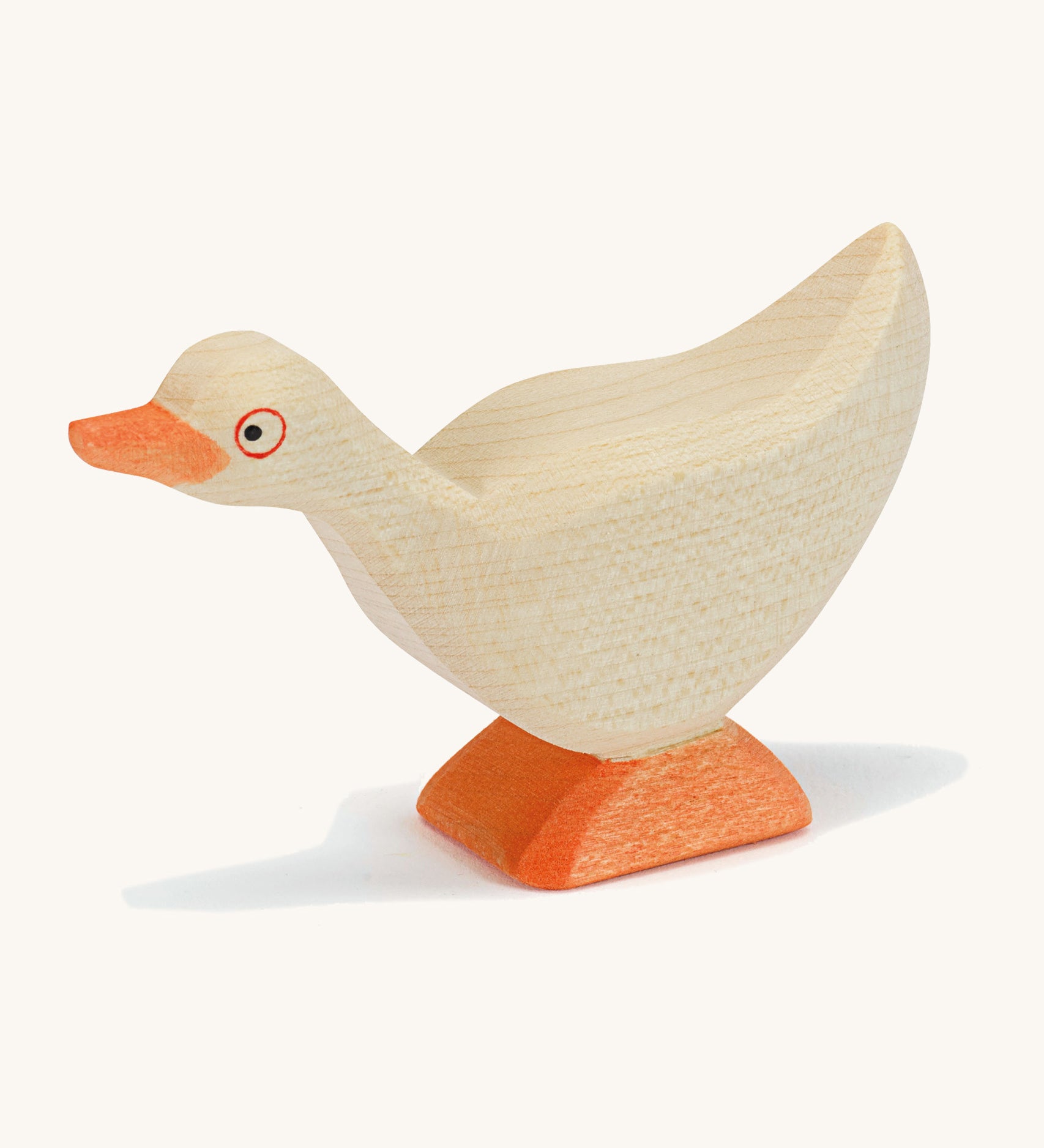 A white wooden Ostheimer standing goose on a cream background.