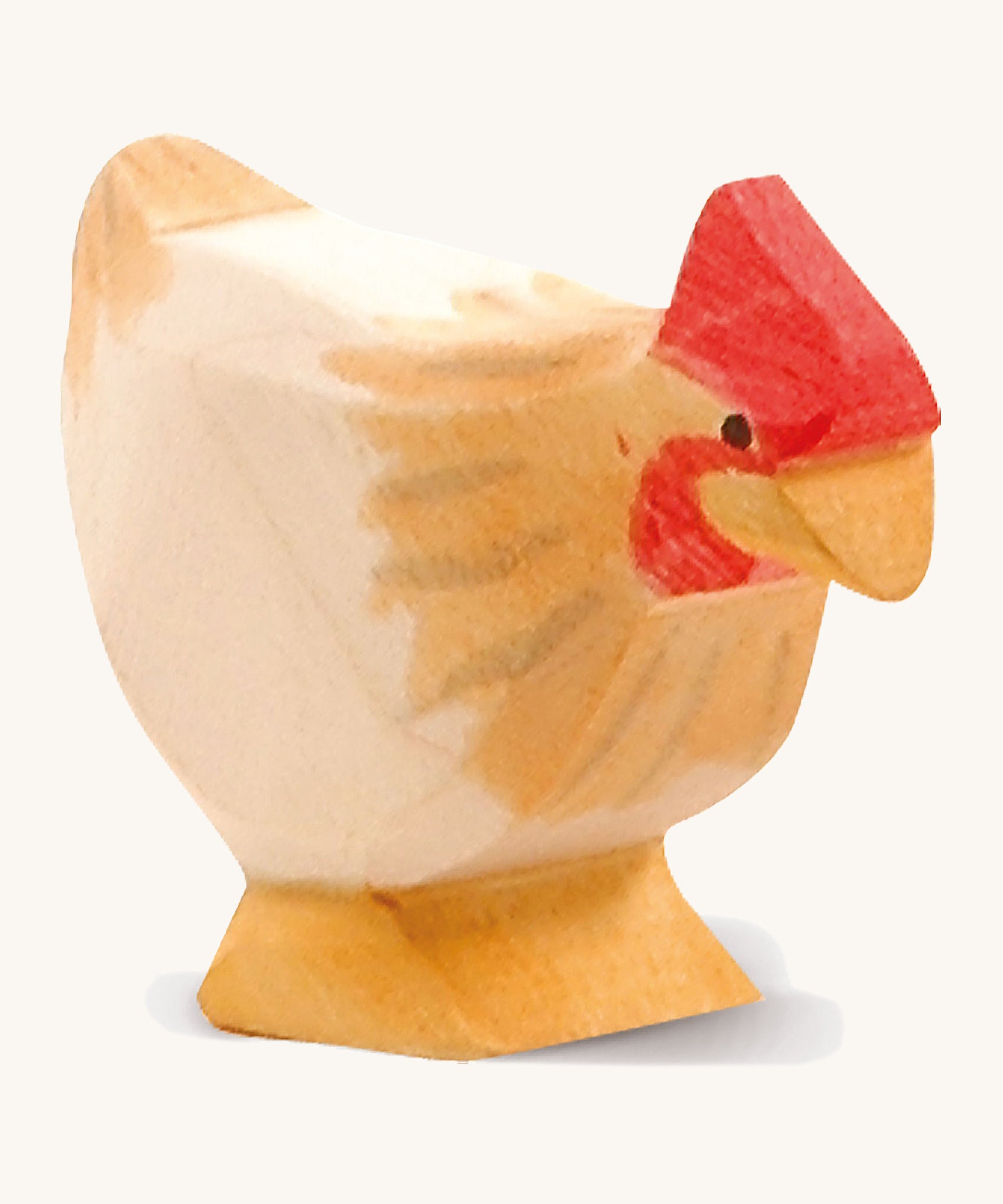 A ochre wooden standing Ostheimer hen figure on a cream background.