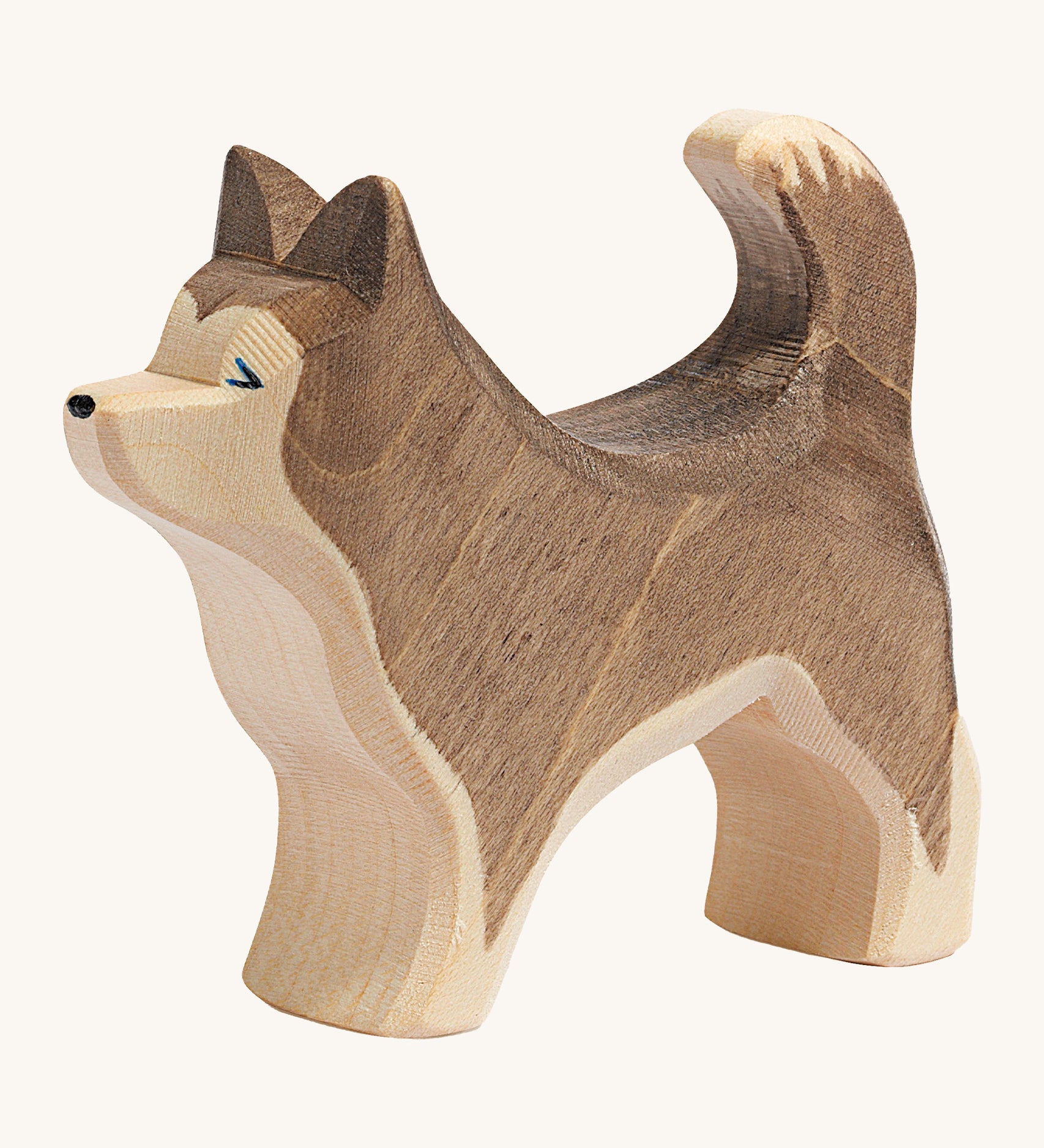 A dark brown wooden Ostheimer standing sled dog on a cream background.