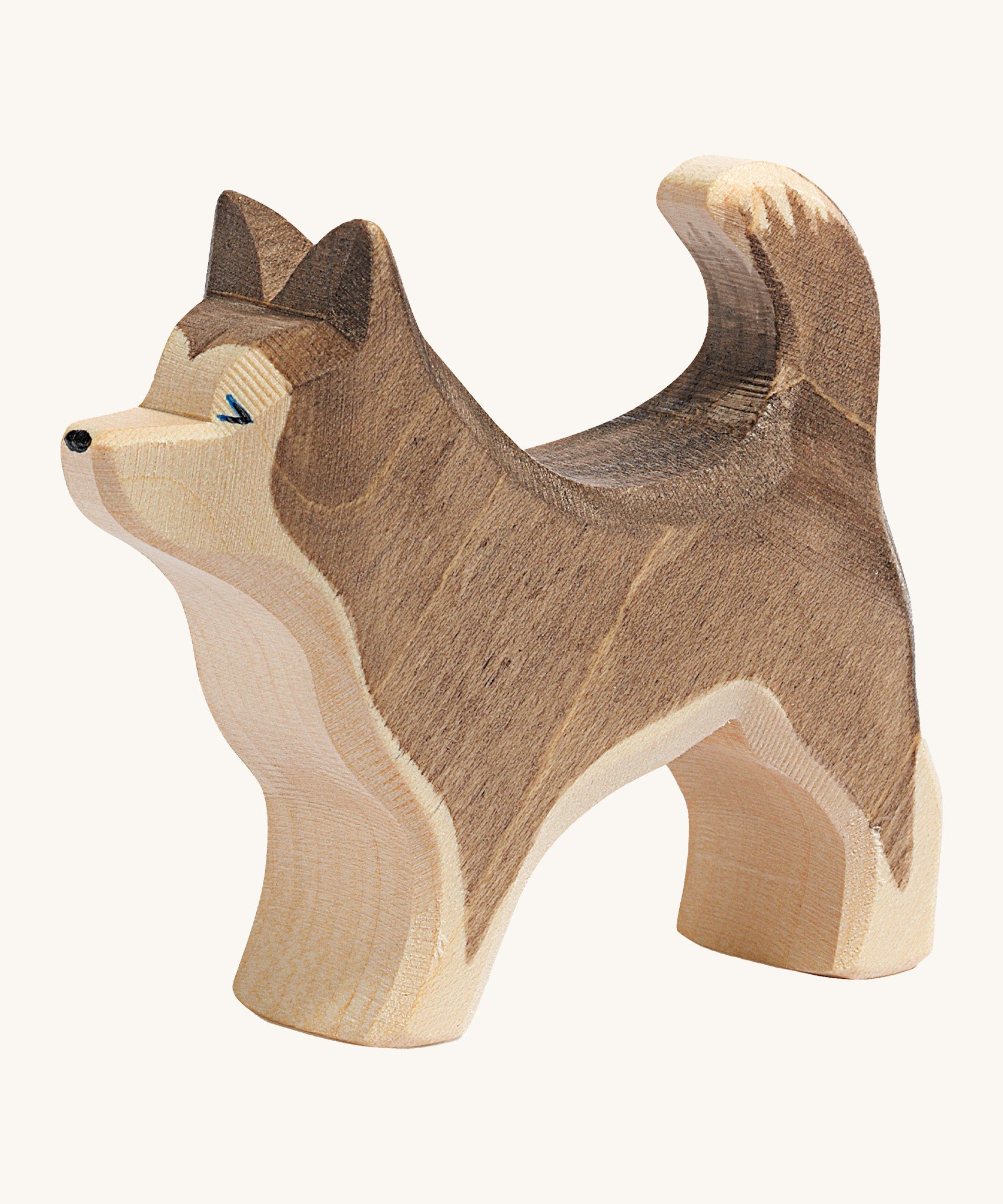 A dark brown wooden Ostheimer standing sled dog on a cream background.