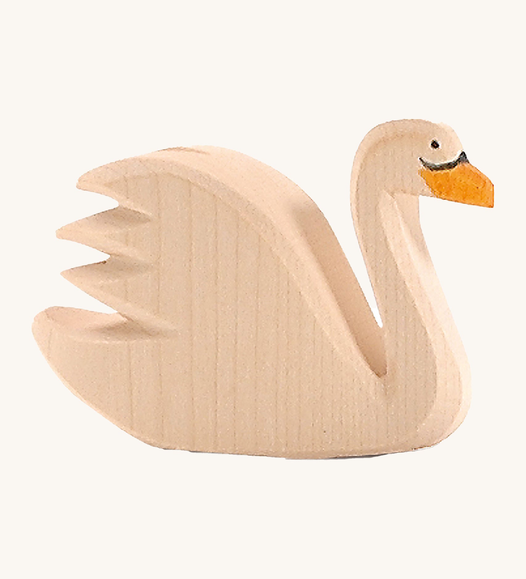 A wooden Ostheimer swan figure on a cream background.