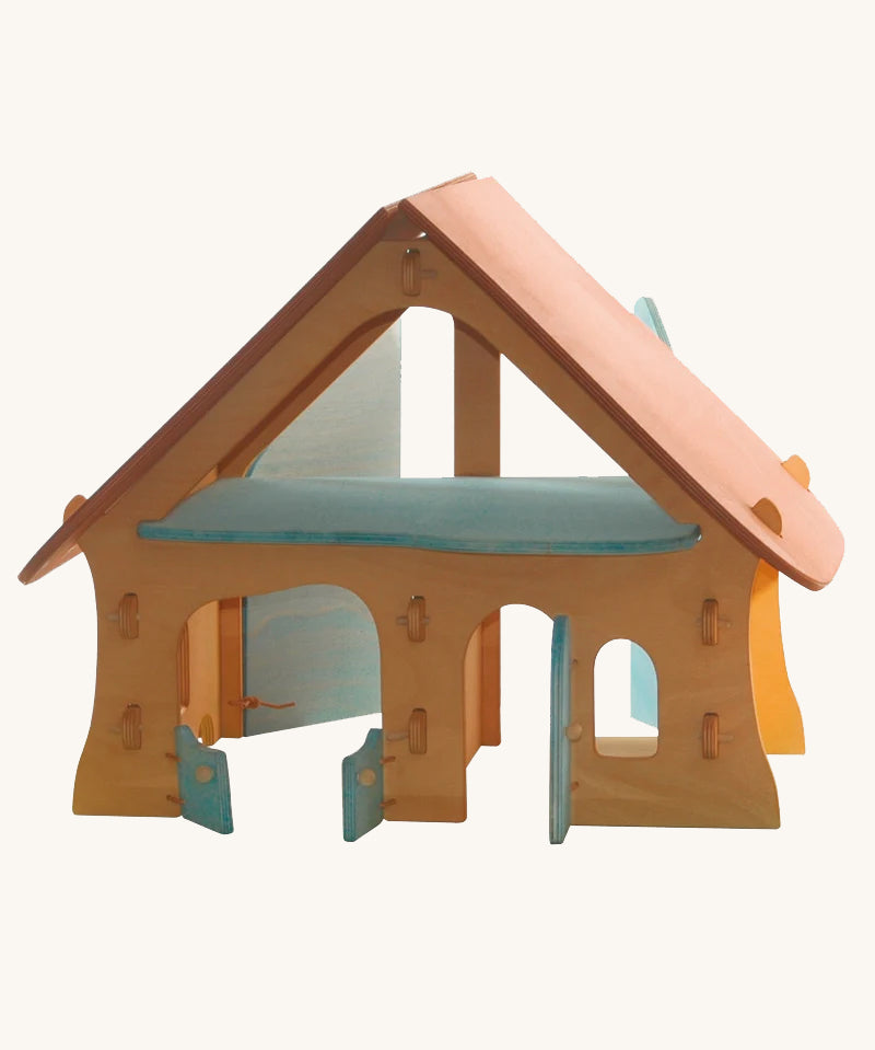 Ostheimer wooden farm house toy with light red roof and light blue doors on a plain background. 