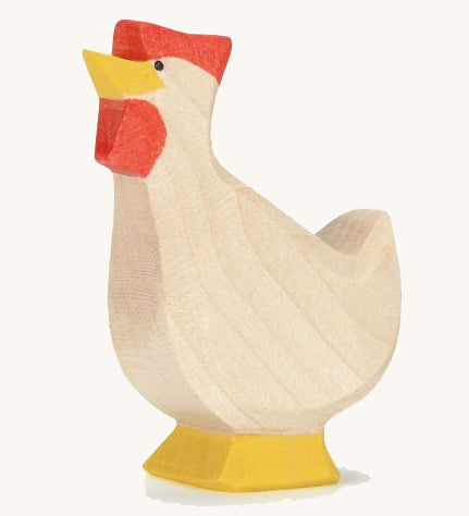 A wooden Ostheimer hen toy with it's head facing up on a plain background. 