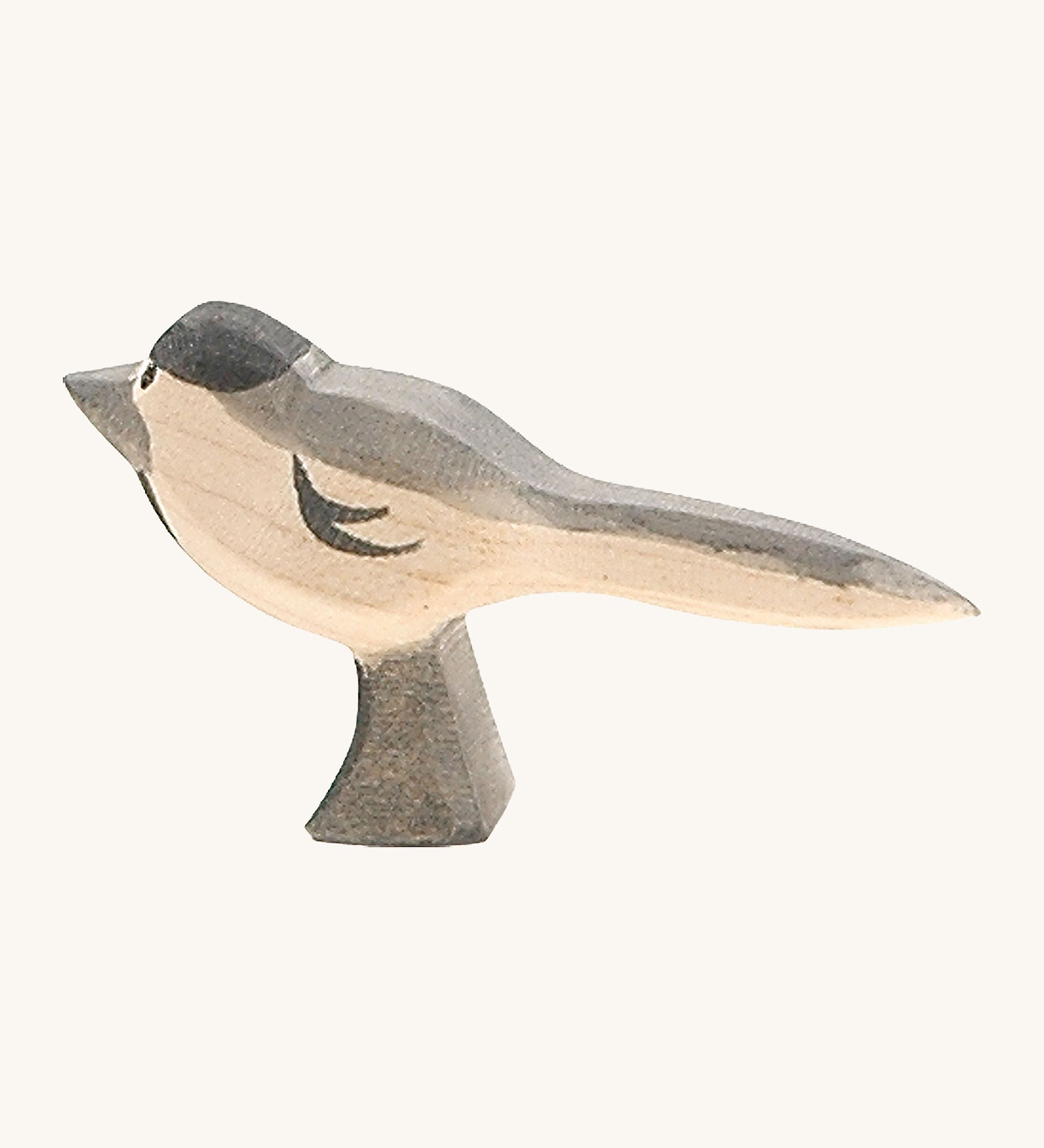 A wooden Ostheimer wagtail figure on a cream background