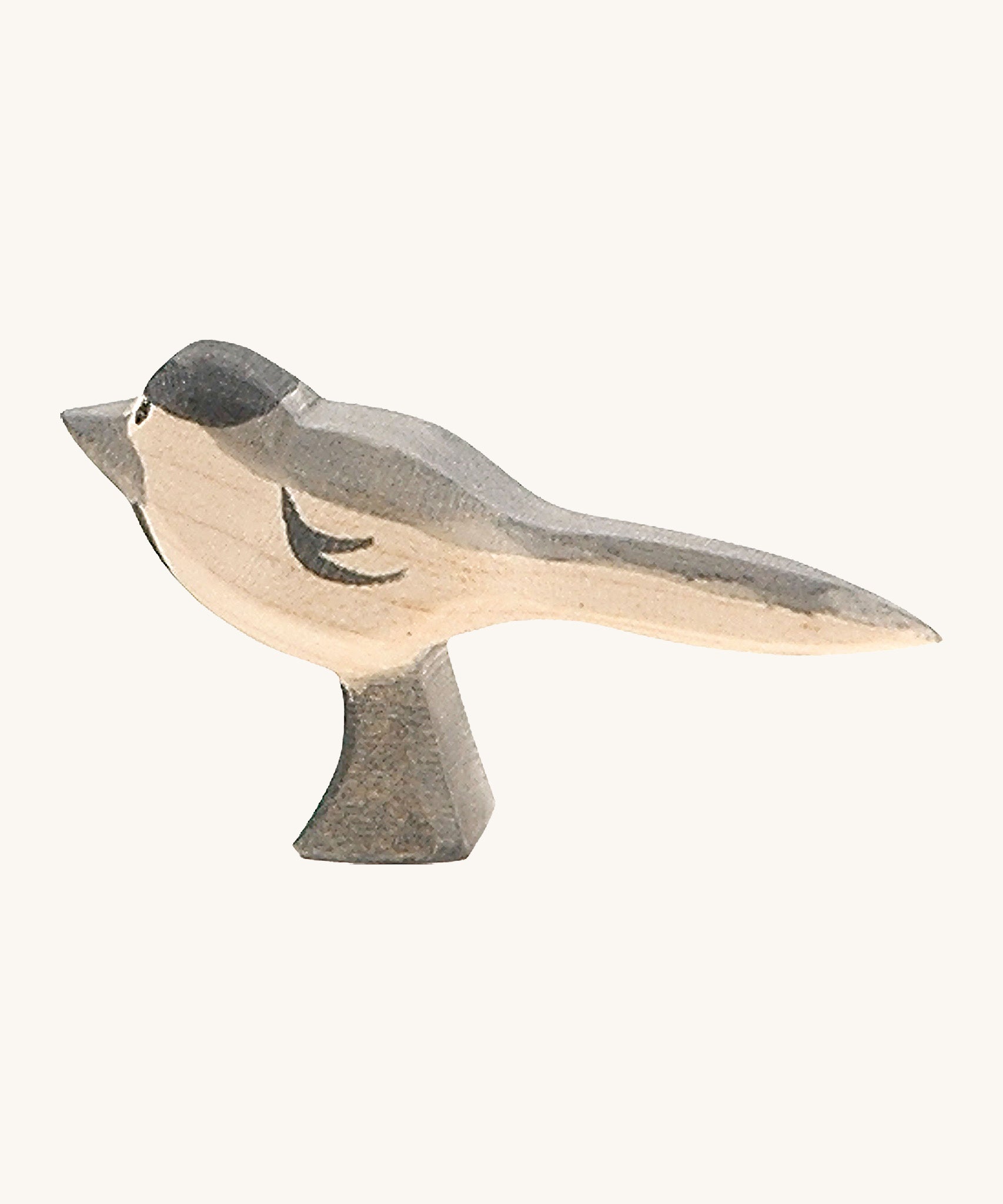 A wooden Ostheimer wagtail figure on a cream background