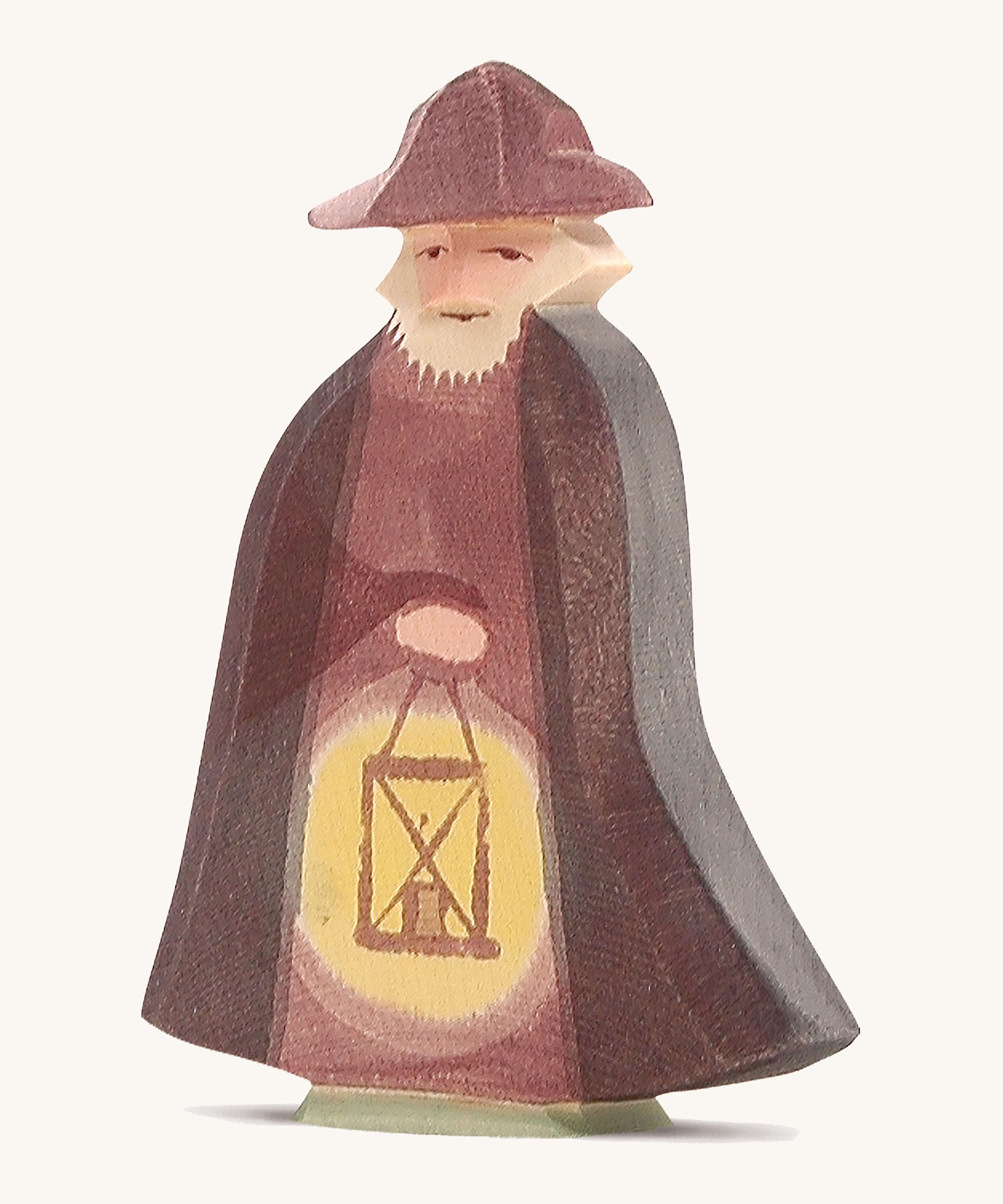 A wooden Ostheimer night watchman figure holding a lantern and wearing a purple cloak and matching purple hat on a cream background.