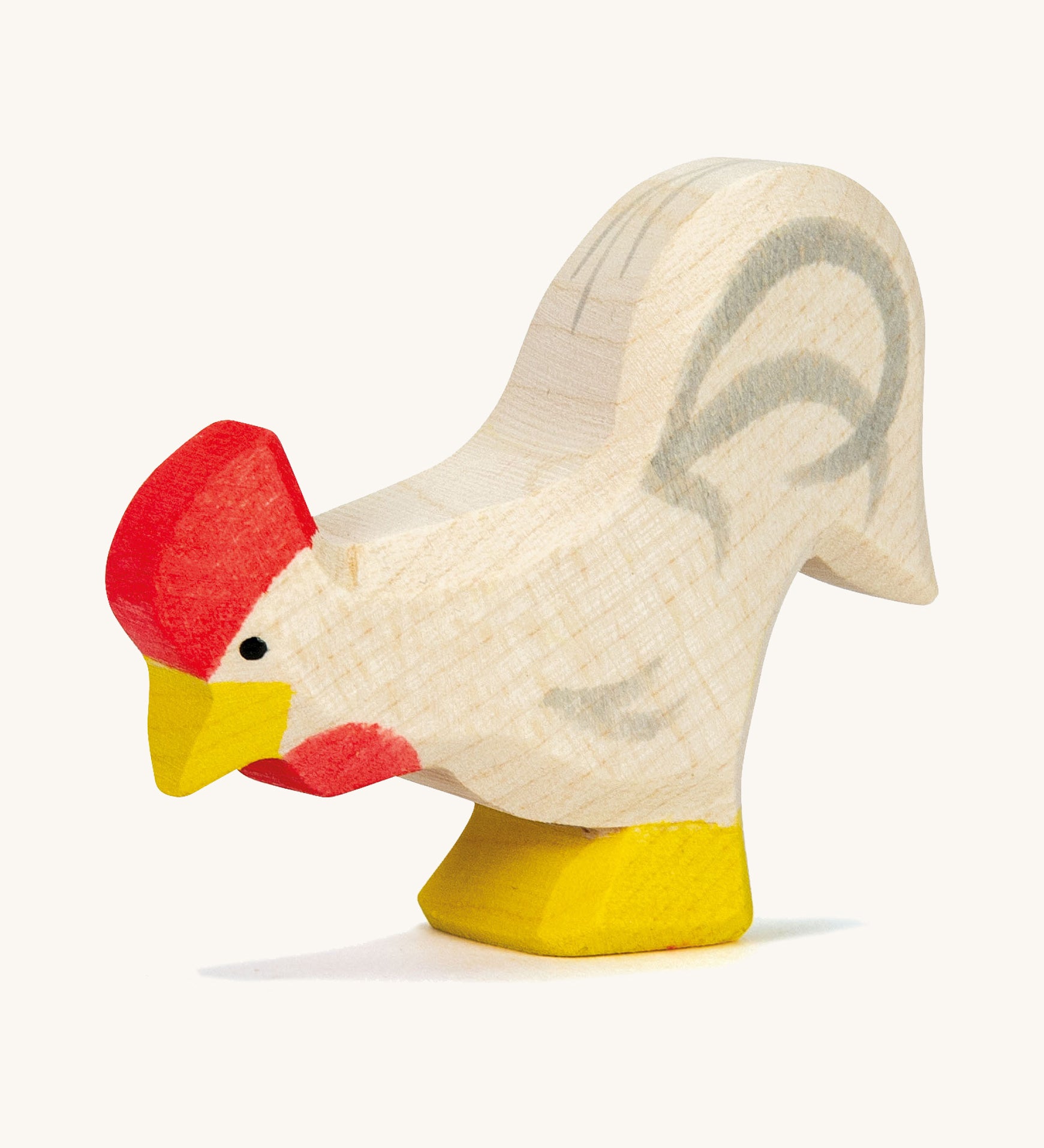 A white wooden Ostheimer rooster on a cream background.