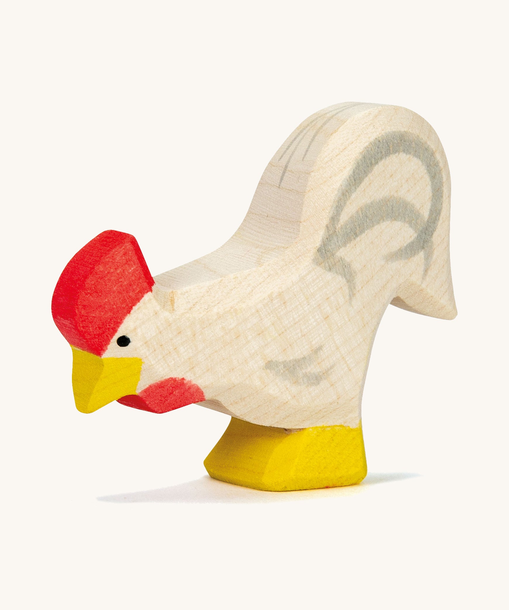 A white wooden Ostheimer rooster on a cream background.