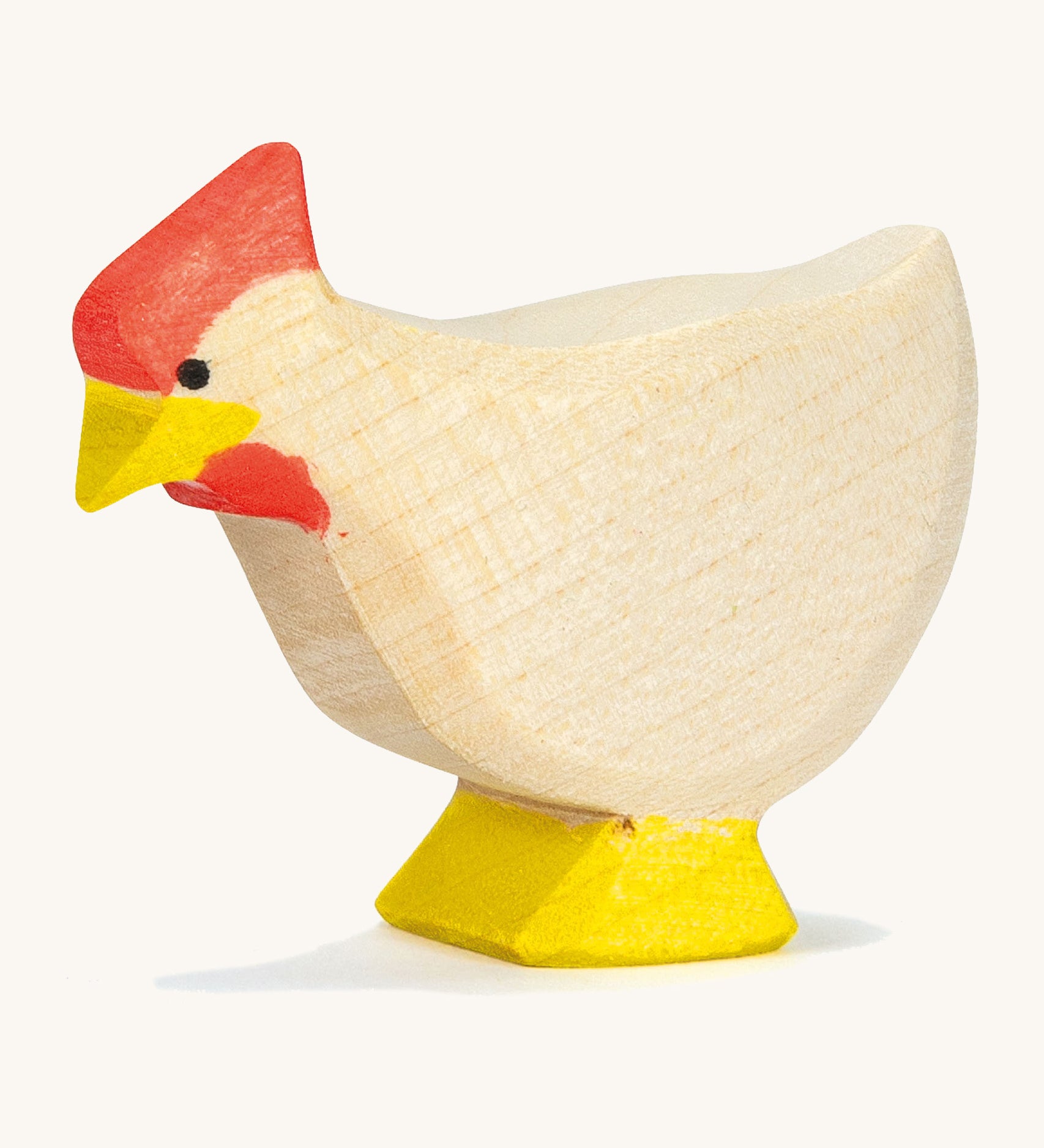 A white wooden standing Ostheimer hen on a cream background.