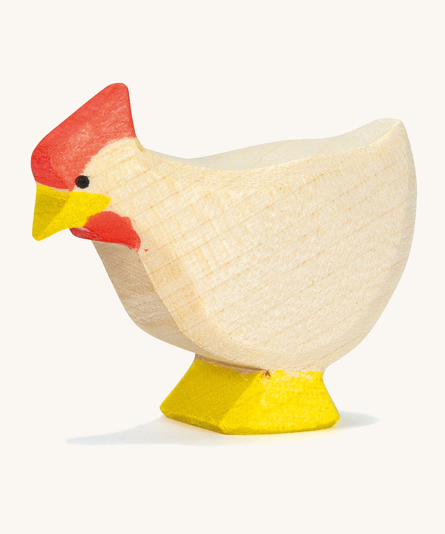 A white wooden standing Ostheimer hen on a cream background.