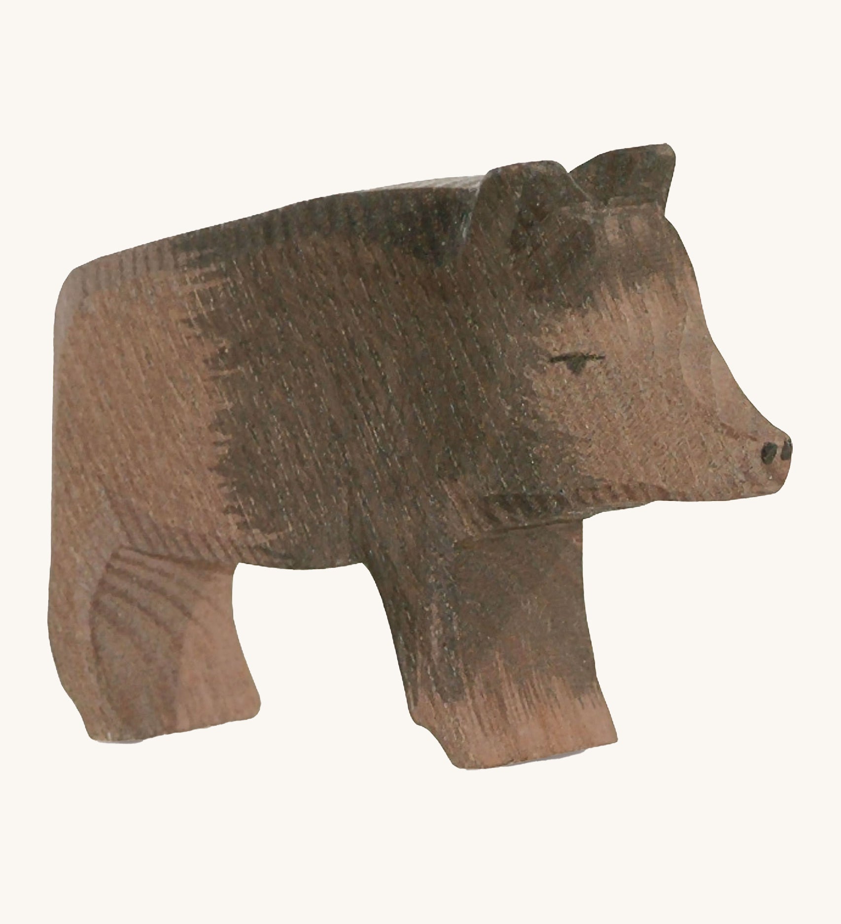 A wooden Ostheimer wild boar sow figure on a cream background.