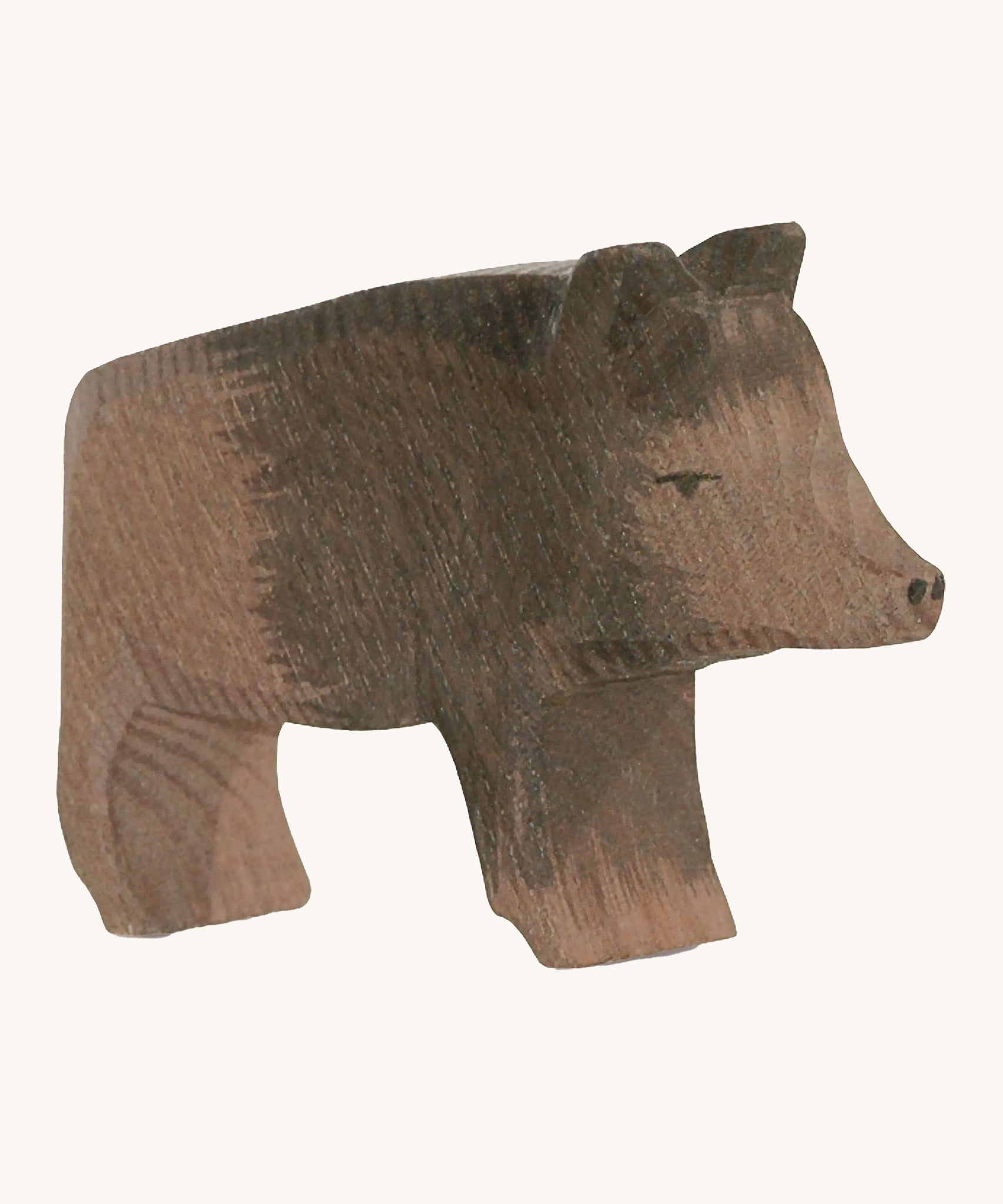 A wooden Ostheimer wild boar sow figure on a cream background.