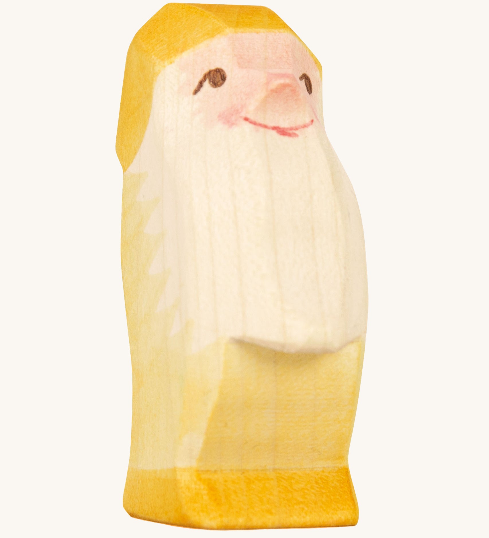 A yellow wooden Ostheimer dwarf figure on a cream background.