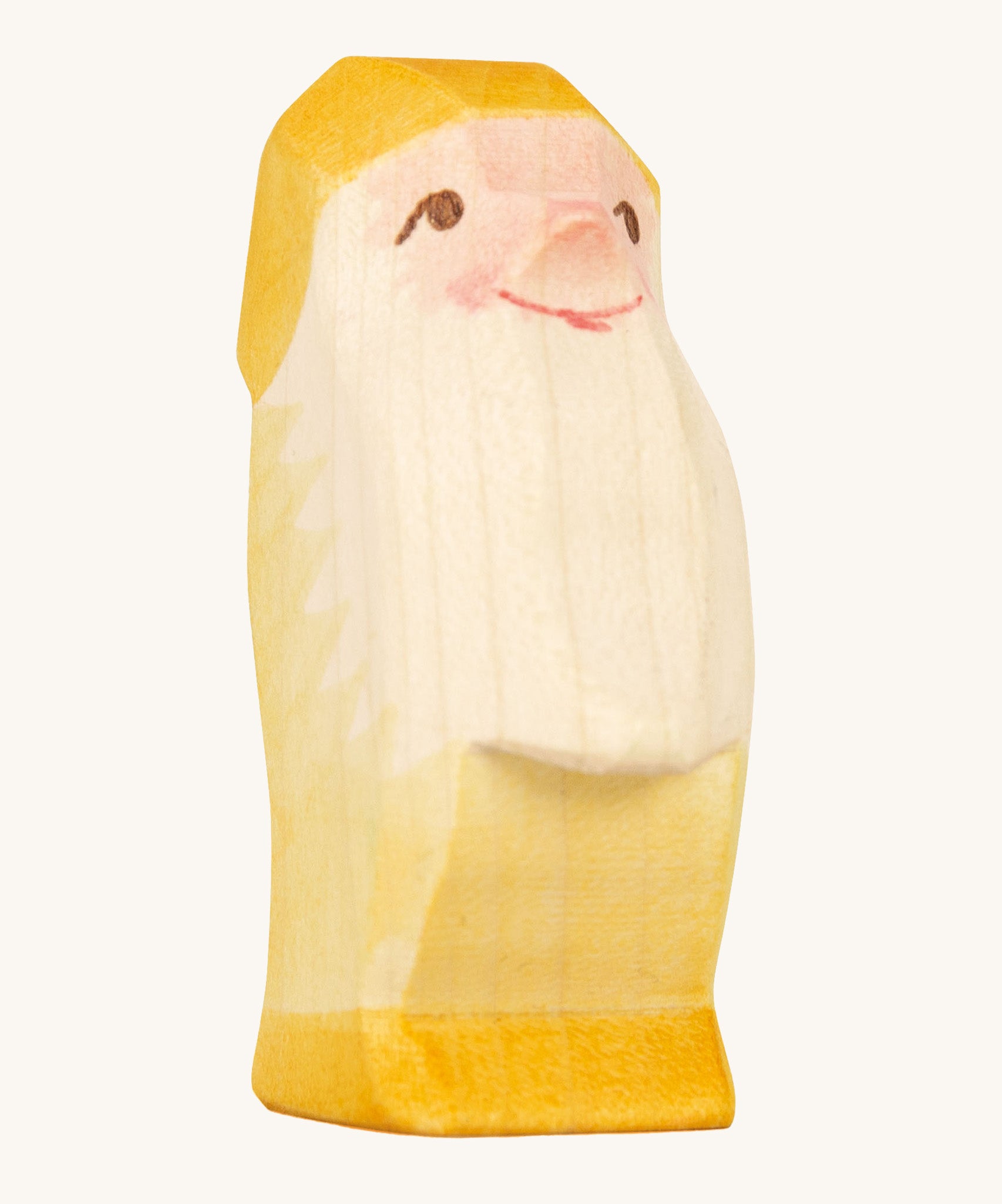 A yellow wooden Ostheimer dwarf figure on a cream background.