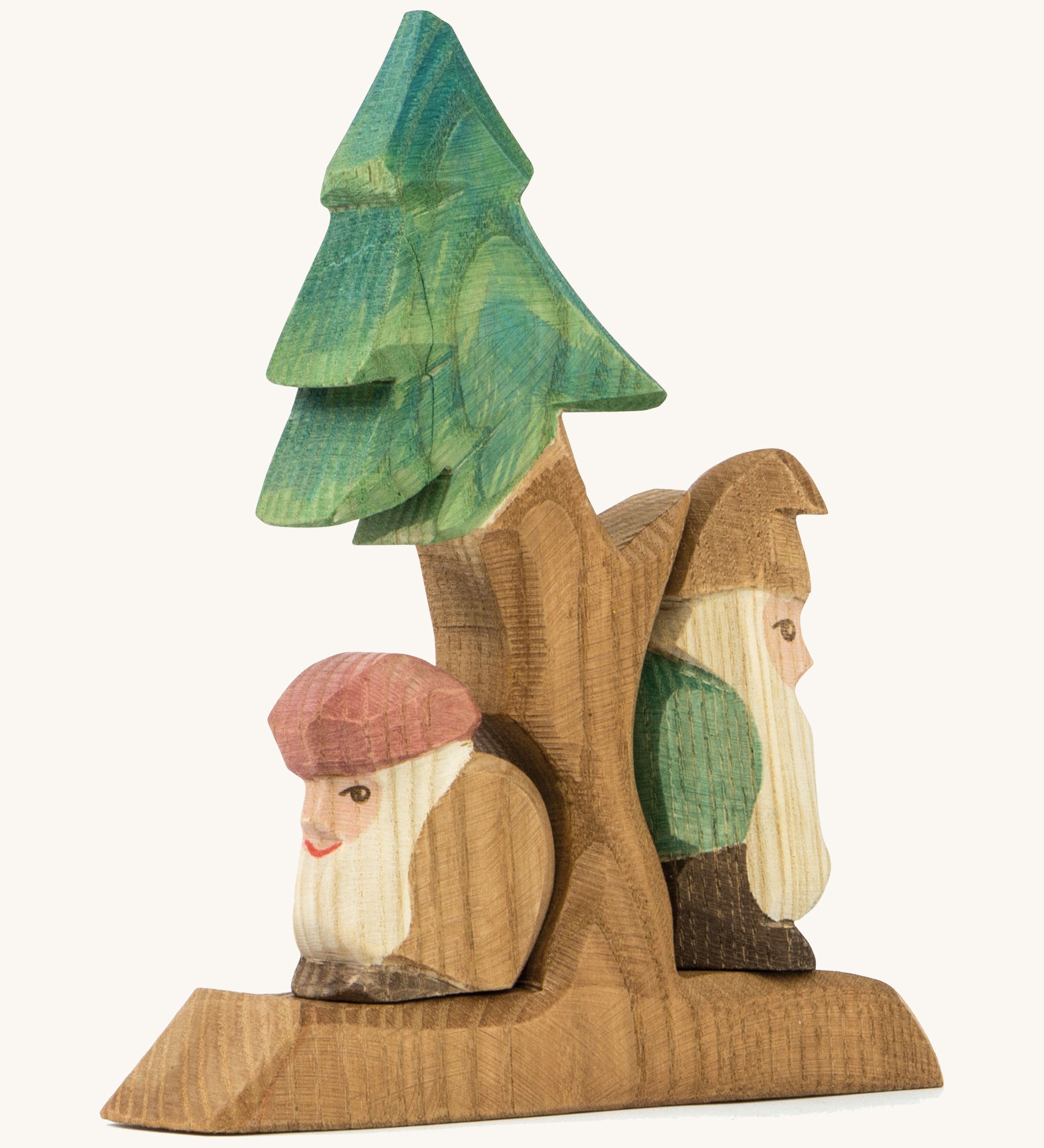 A wooden Ostheimer fir tree with Ostheimer dwarves standing on the stand on a cream background.