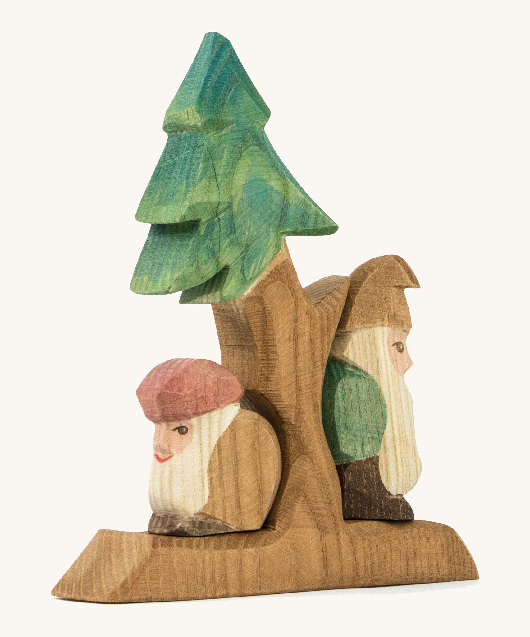 A wooden Ostheimer fir tree with Ostheimer dwarves standing on the stand on a cream background.