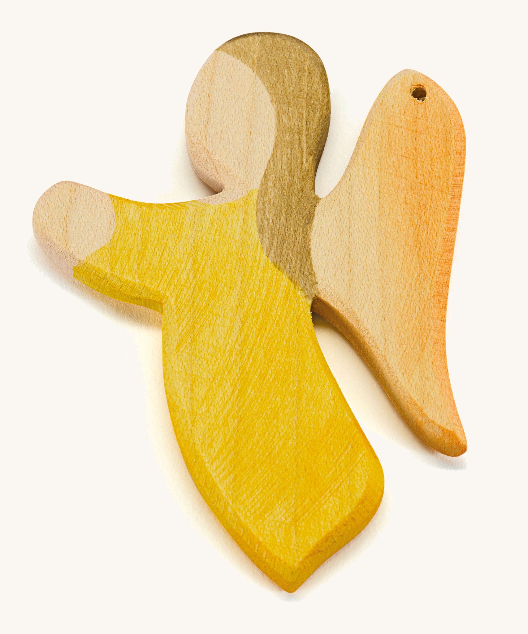 A yellow wooden angel figure on a cream background