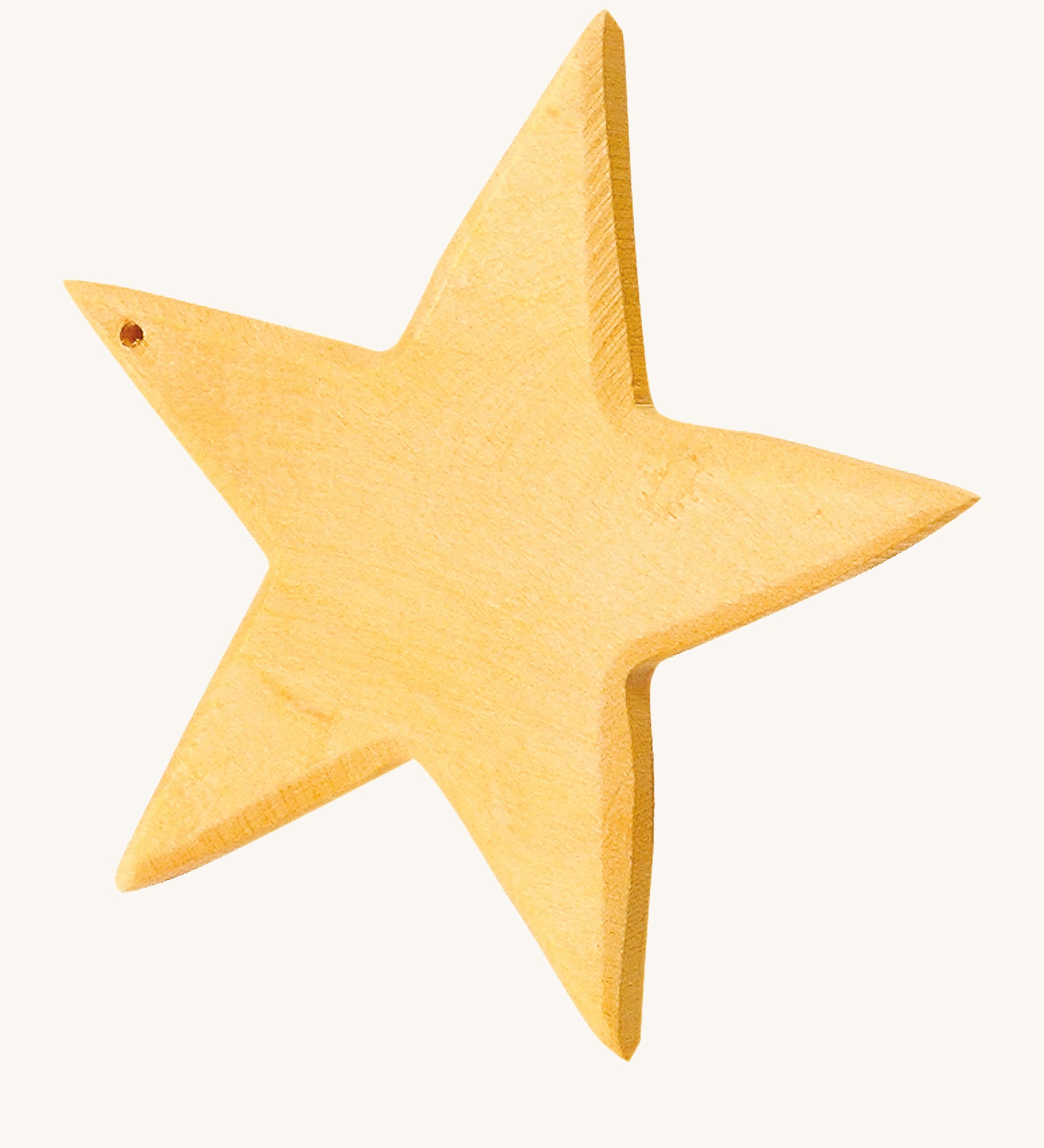 A yellow wooden star figure on a cream background