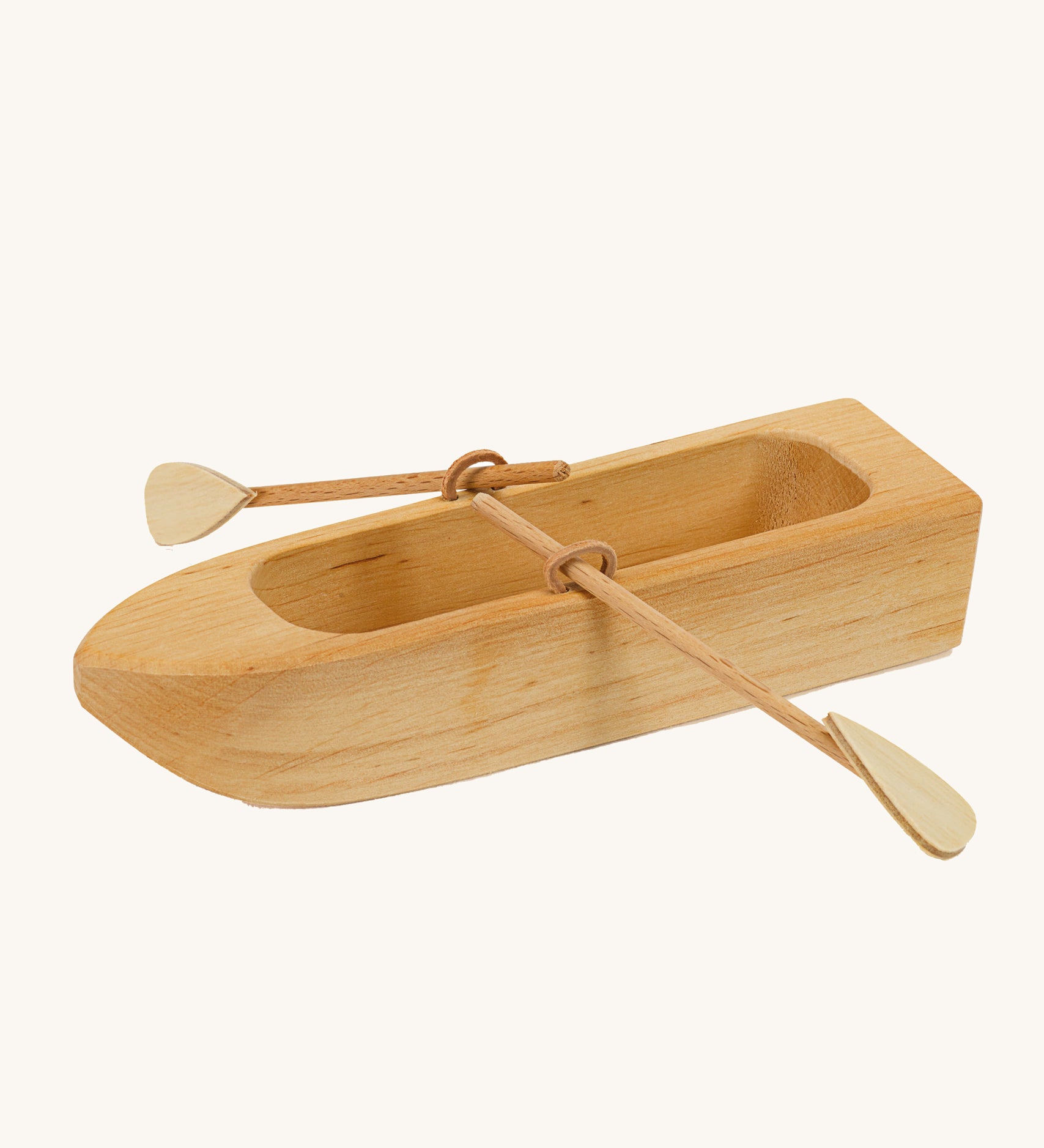 Ostheimer wooden lifeboat toy with paddles on a plain background.