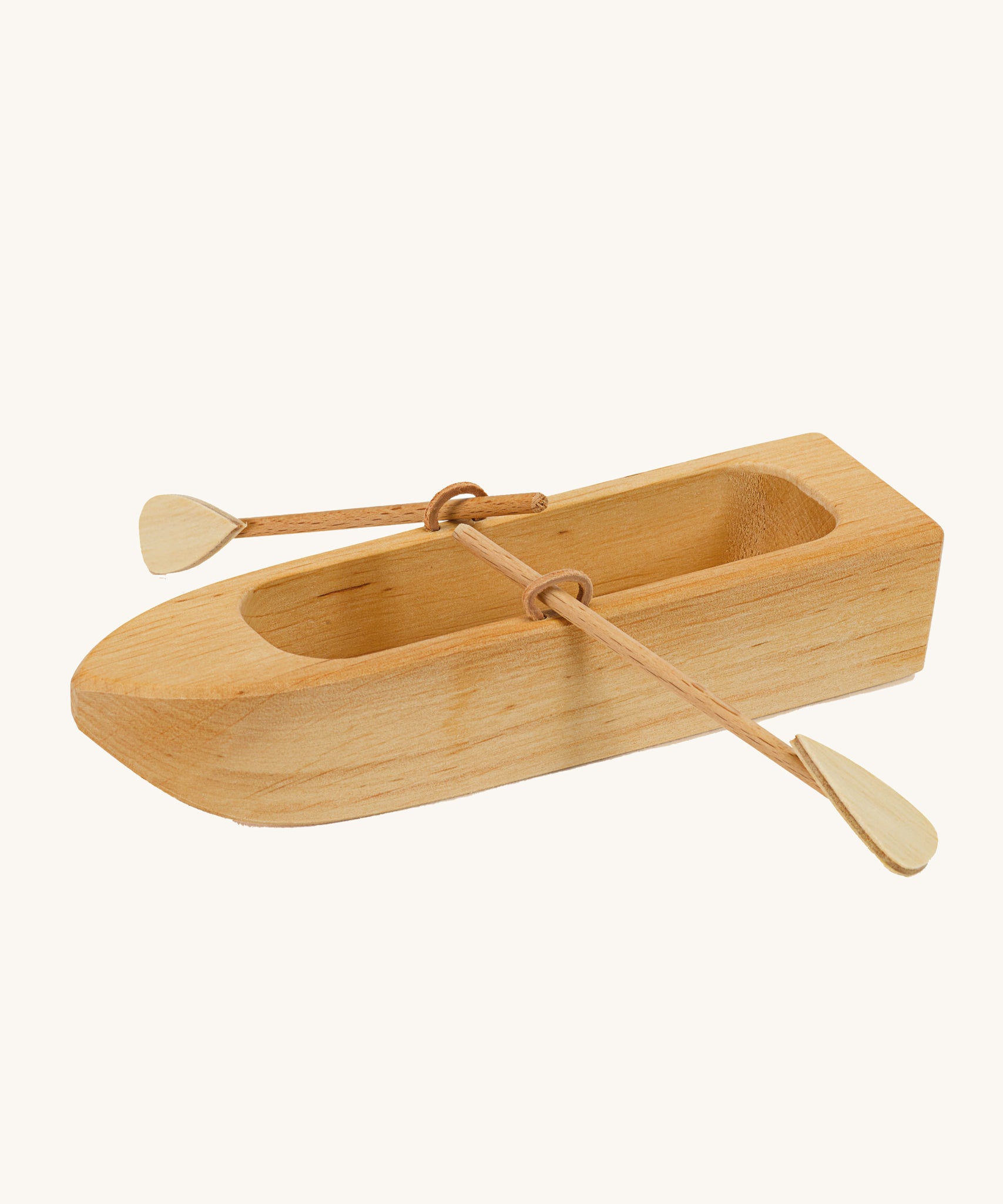 Ostheimer wooden lifeboat toy with paddles on a plain background.