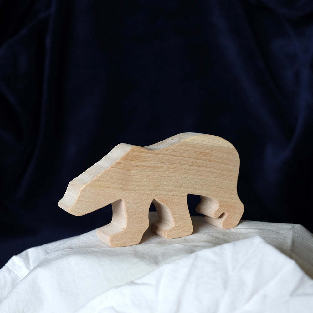 O-WOW handmade eco-friendly maple wood polar bear on a white sheet in front of a black background