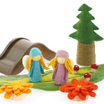 2 Papoose rainbow flowers on a white background in front of a green play mat with Papoose trees and a wooden bridge toy