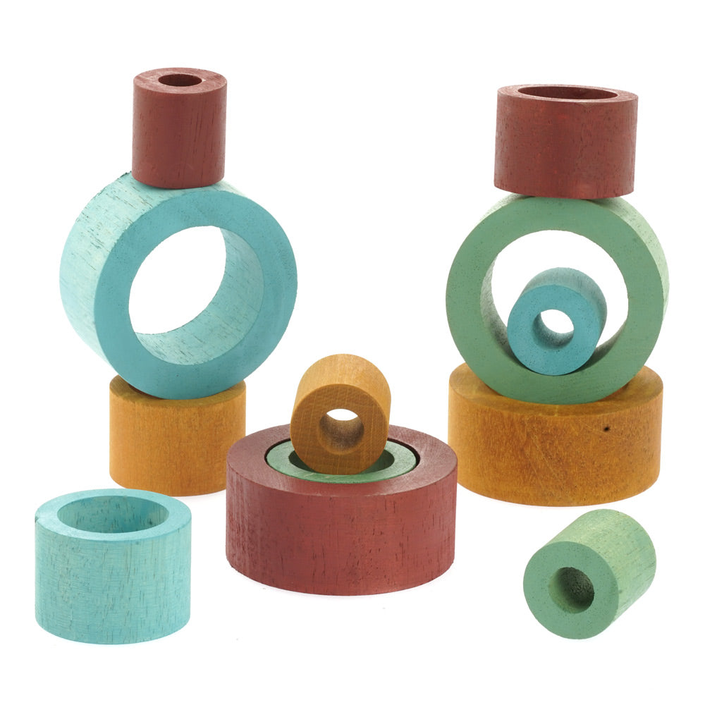 Papoose solid wooden coloured earth nesting tubes stacked in random towers on a white background