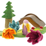 3 Papoose handmade felt daffodil flowers on a green play mat next to a Papoose bright elf