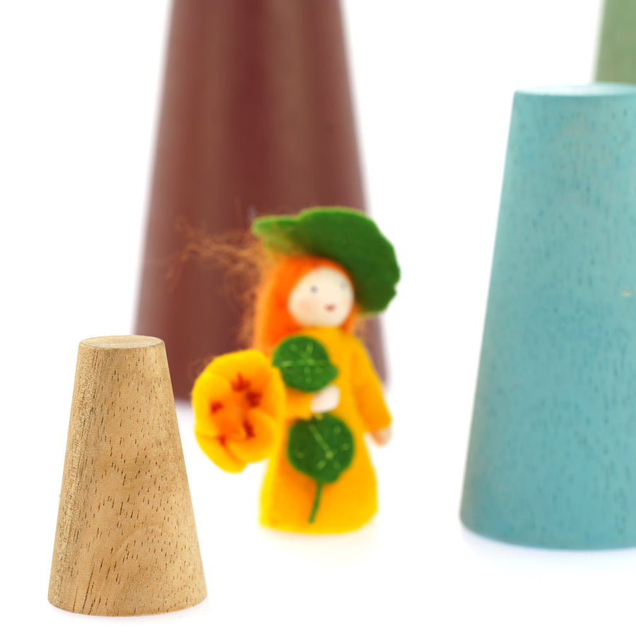 Close up of a Papoose natural wooden waldorf cone next to an orange Ambrosius toy figure and Papoose coloured stacking cones